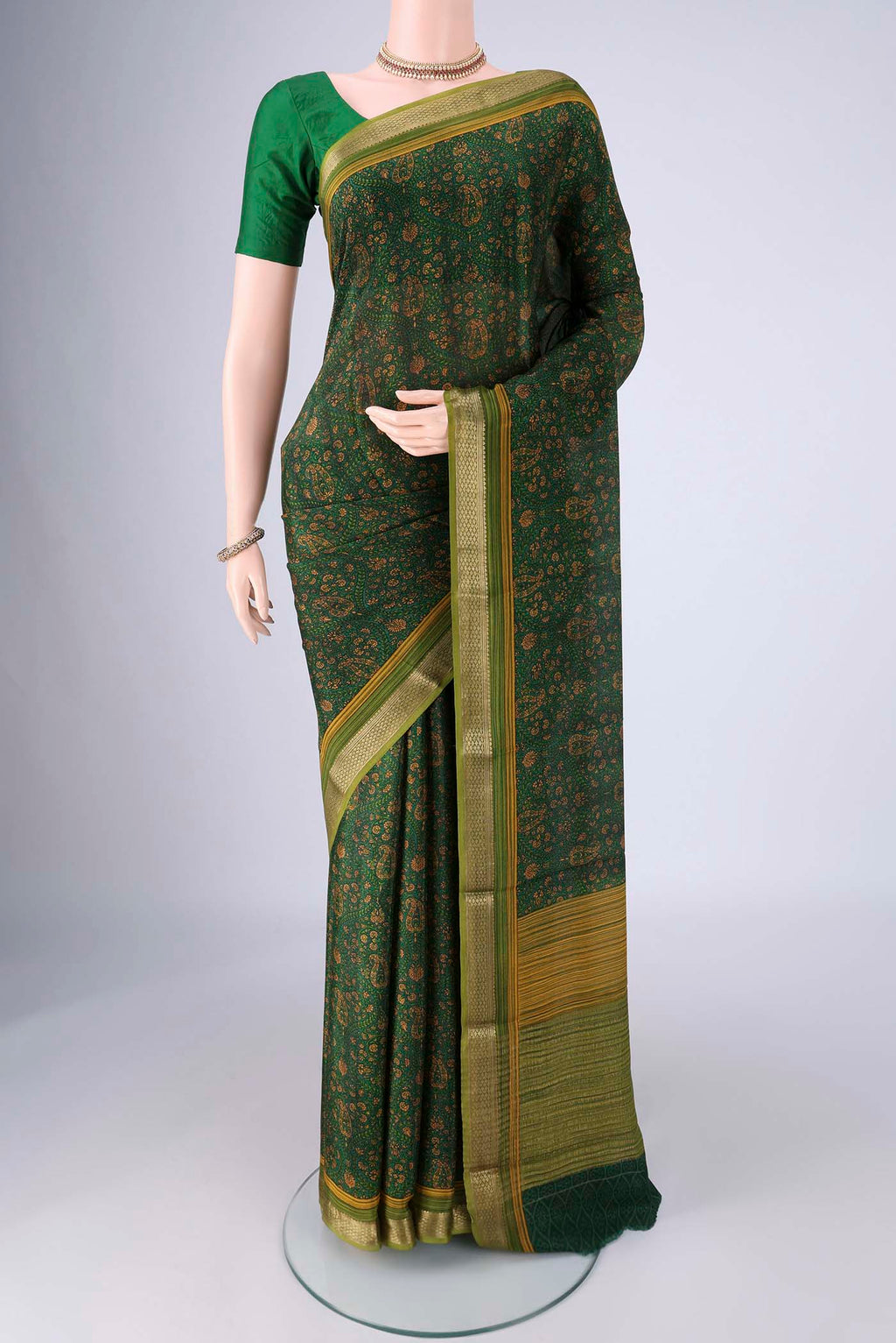 Bottle Green Mysore Crepe Saree with Printed design on the body and Zari Border.  displayed on a mannequin