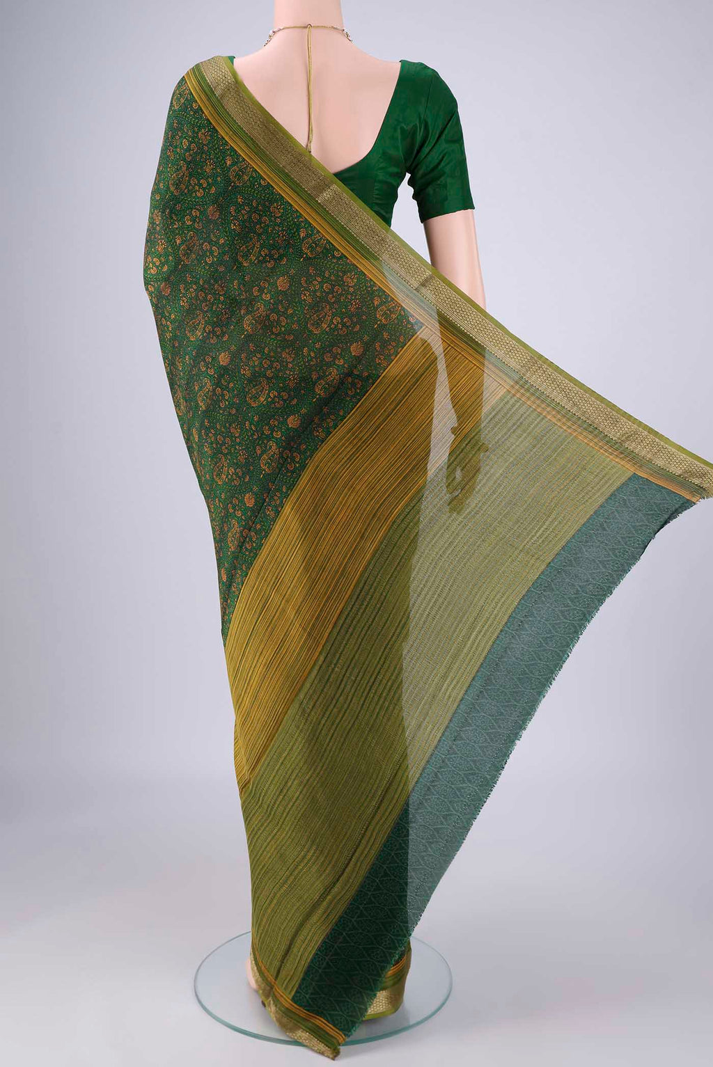 Flat view of Bottle Green Mysore Crepe Saree with Printed design on the body and Zari Border. 