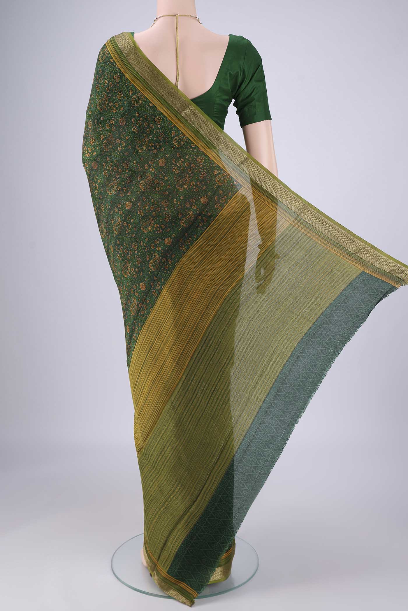 Flat view of Bottle Green Mysore Crepe Saree with Printed design on the body and Zari Border. 