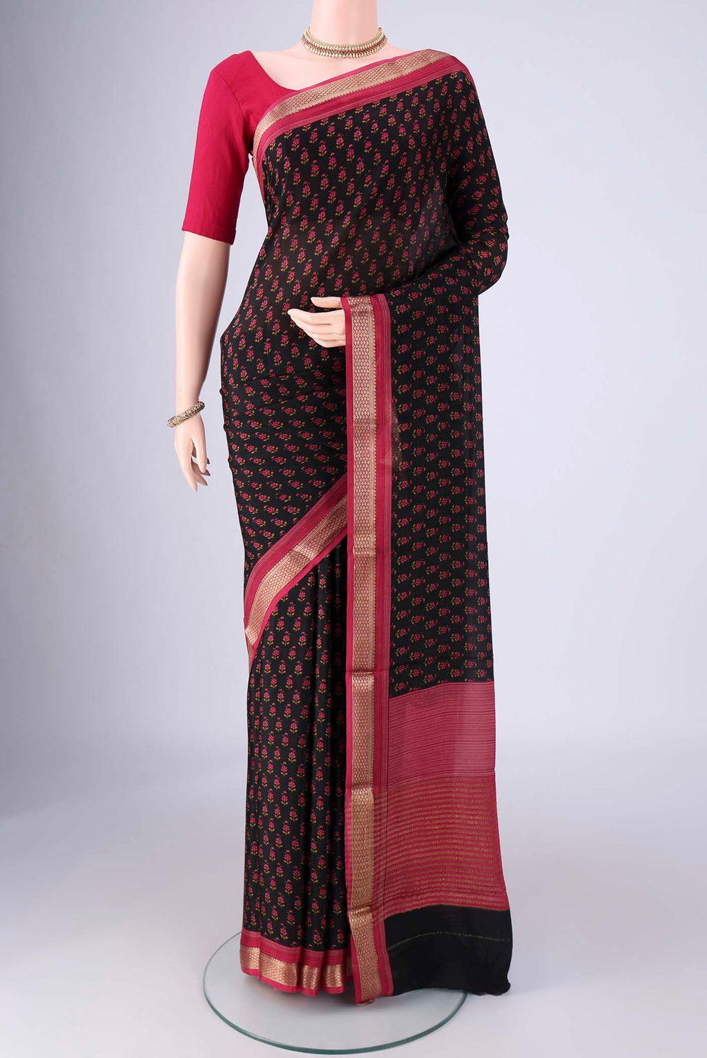 Black Mysore Crepe Saree with Printed design on the body and Zari Border.  displayed on a mannequin