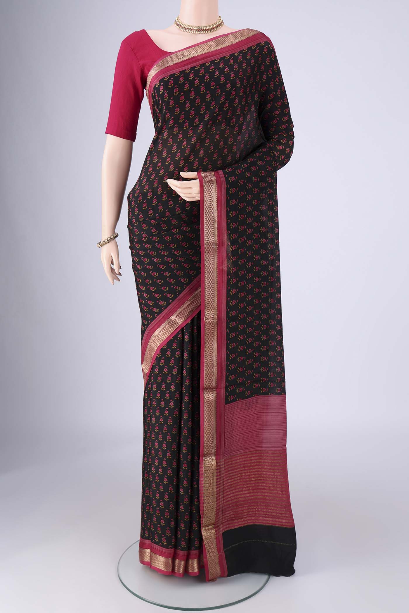 Black Mysore Crepe Saree with Printed design on the body and Zari Border.  displayed on a mannequin
