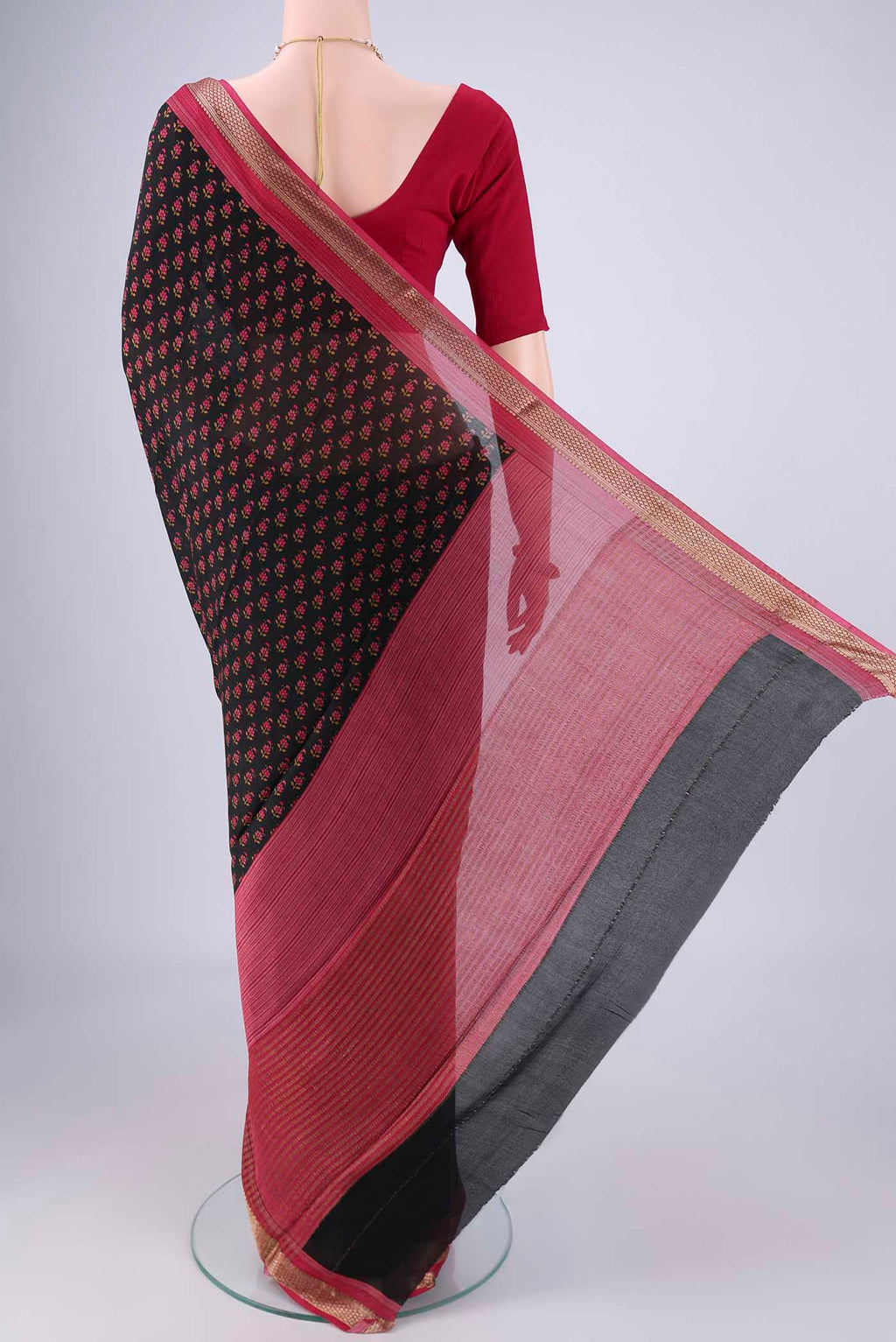 Flat view of Black Mysore Crepe Saree with Printed design on the body and Zari Border. 