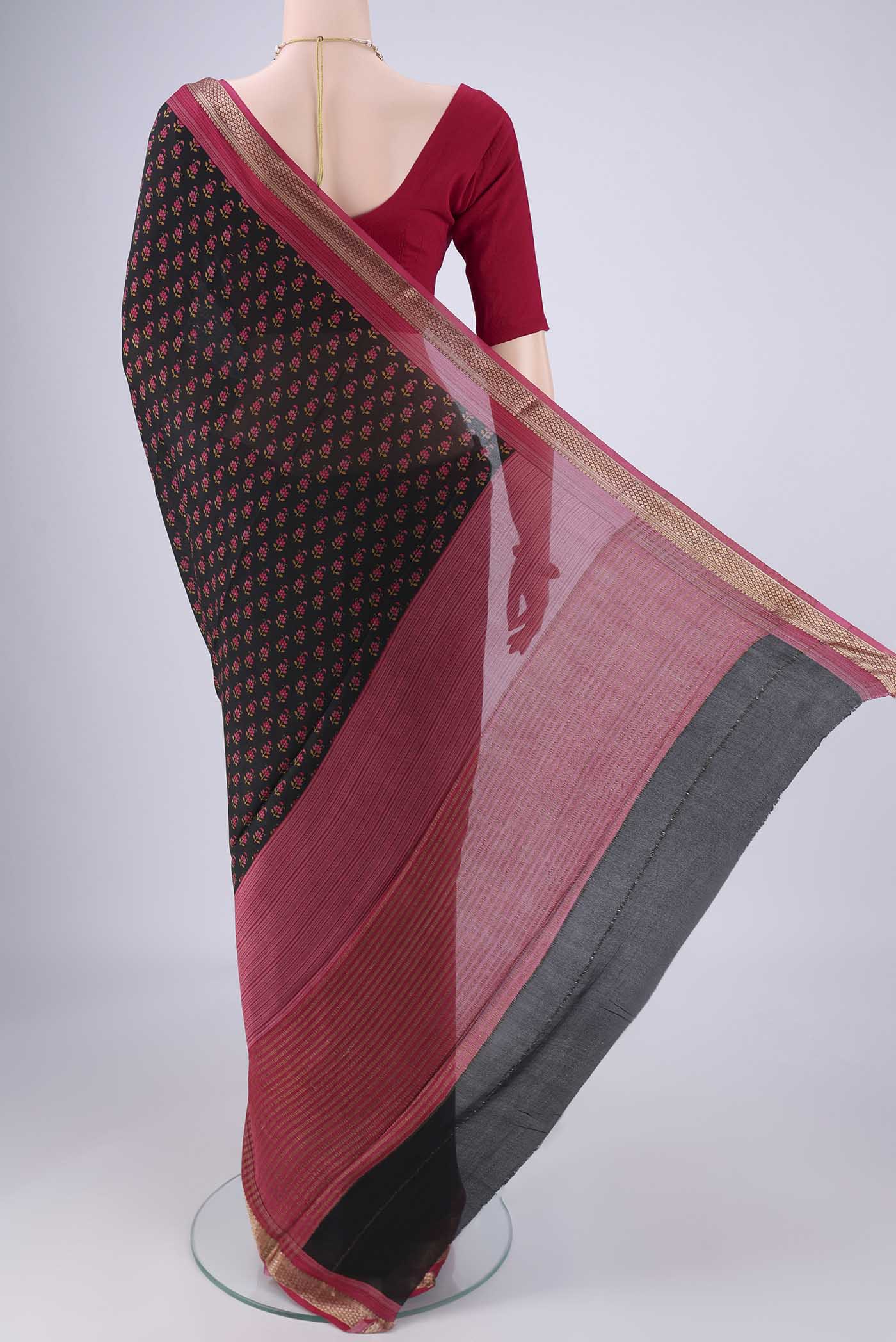 Flat view of Black Mysore Crepe Saree with Printed design on the body and Zari Border. 