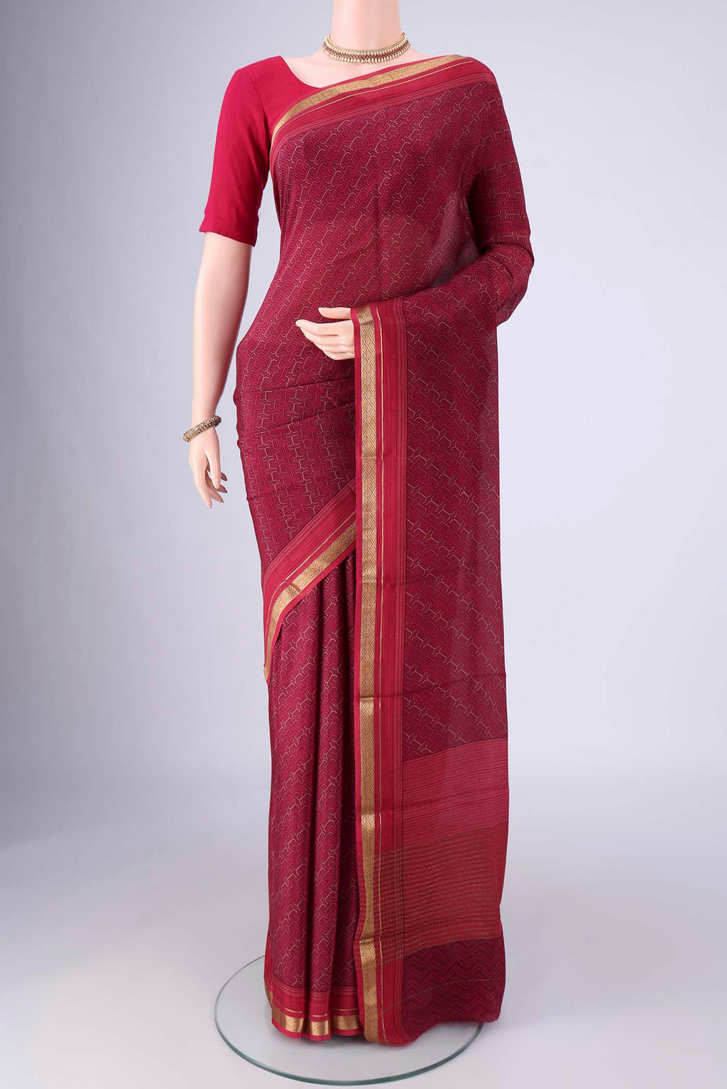 Magenta Mysore Crepe Saree with Printed design on the body and Zari Border.  displayed on a mannequin