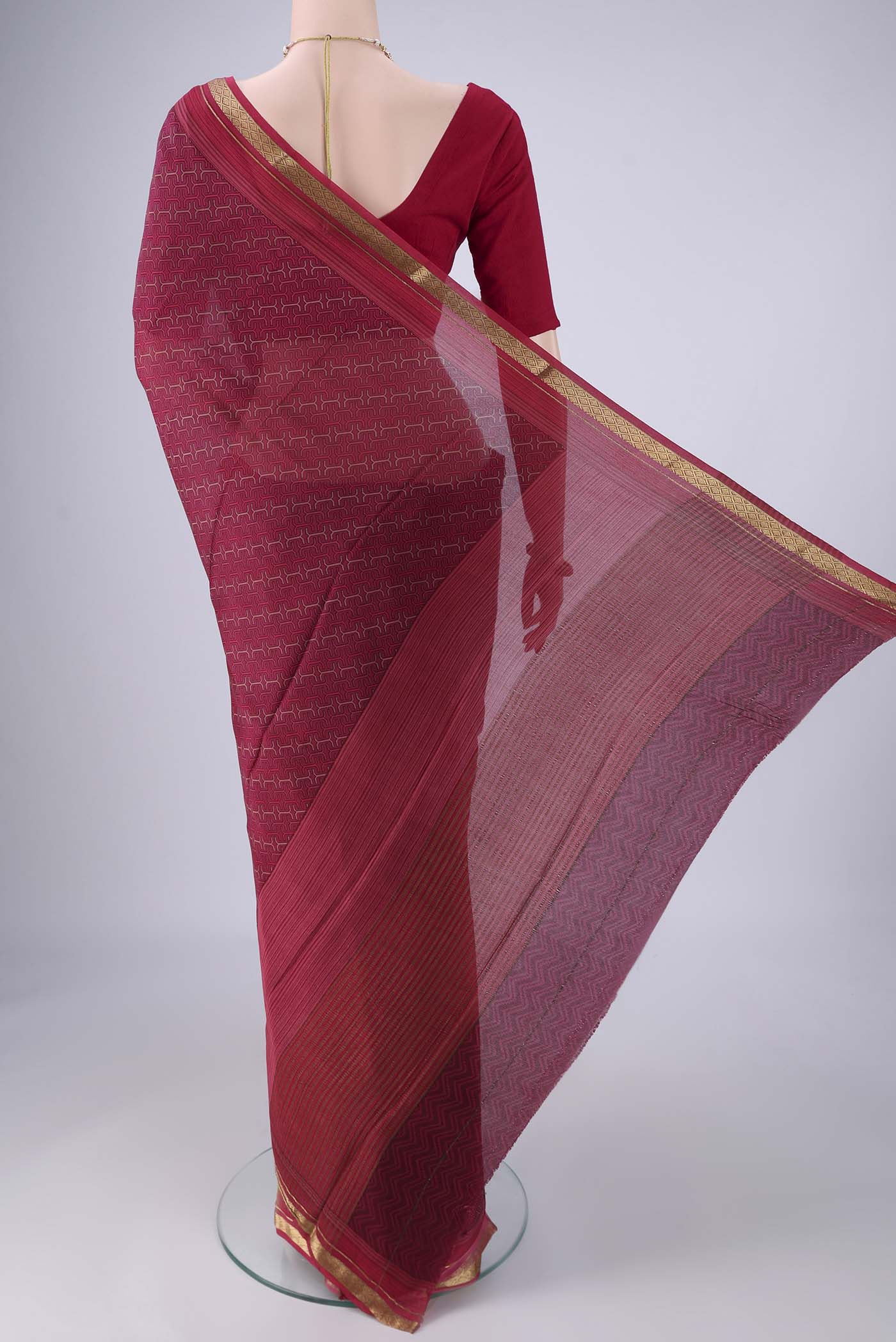 Flat view of Magenta Mysore Crepe Saree with Printed design on the body and Zari Border. 
