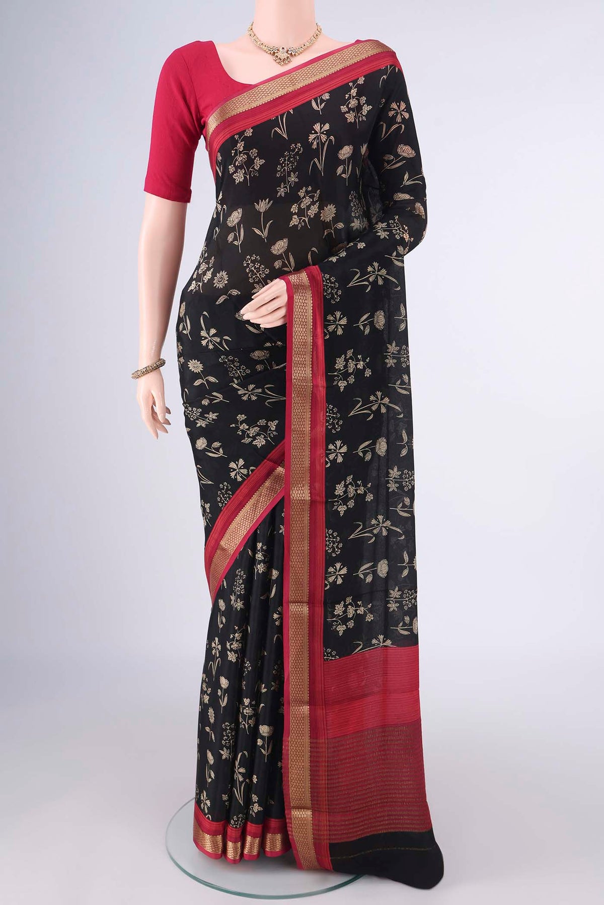 Black Mysore Crepe Saree with Printed design on the body and Zari Border.  displayed on a mannequin