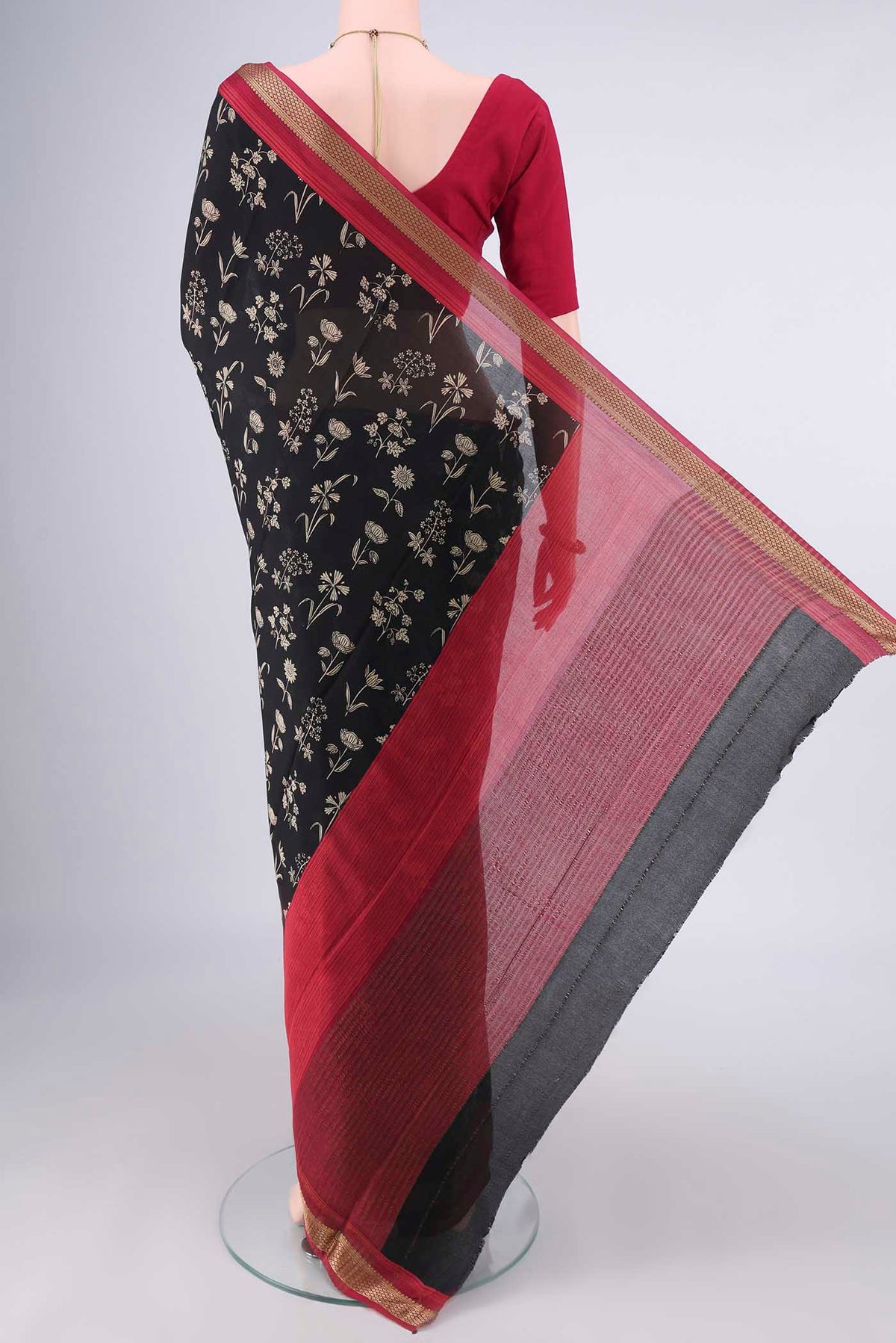 Flat view of Black Mysore Crepe Saree with Printed design on the body and Zari Border. 