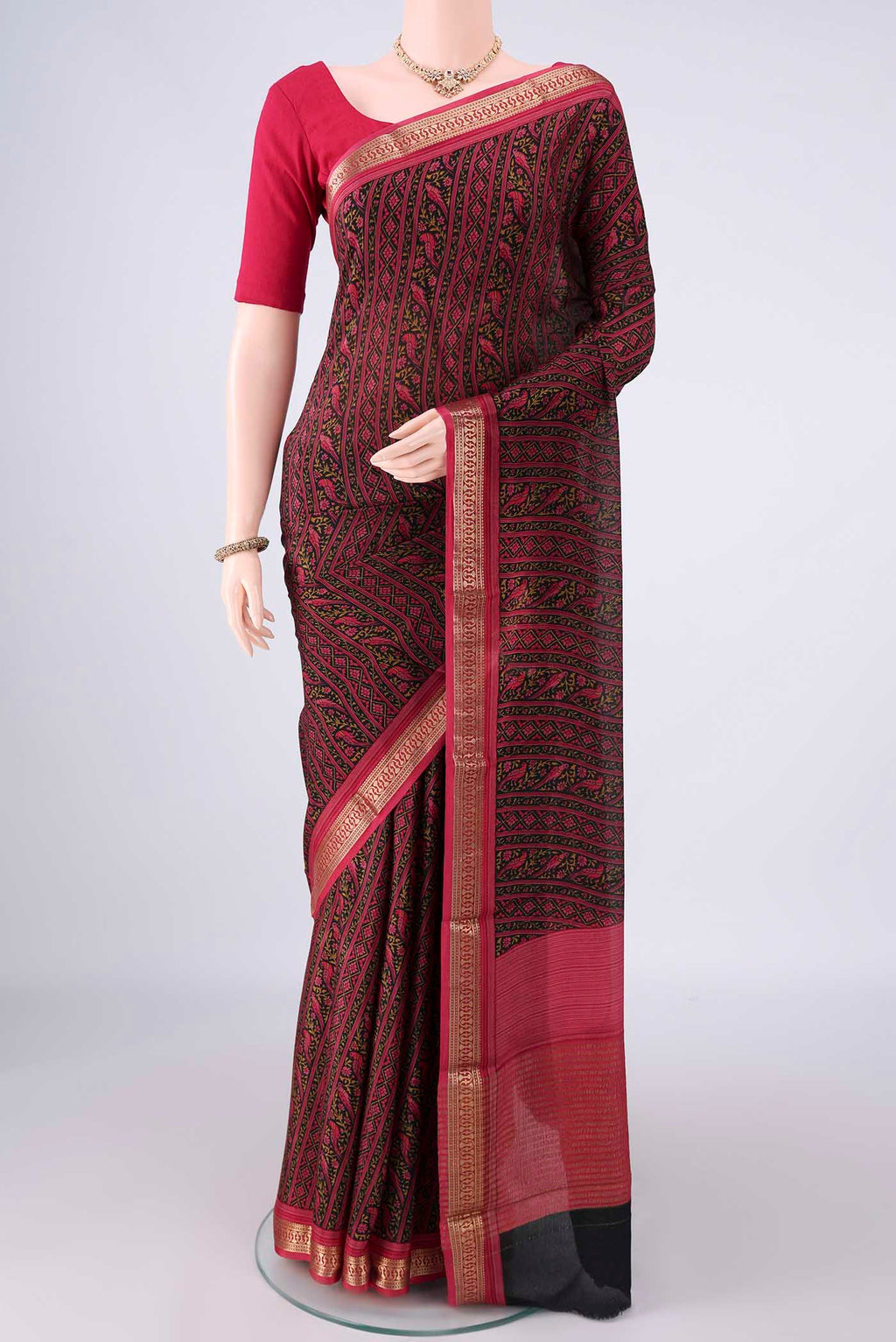 Black Mysore Crepe Saree with Printed design on the body and Zari Border.  displayed on a mannequin