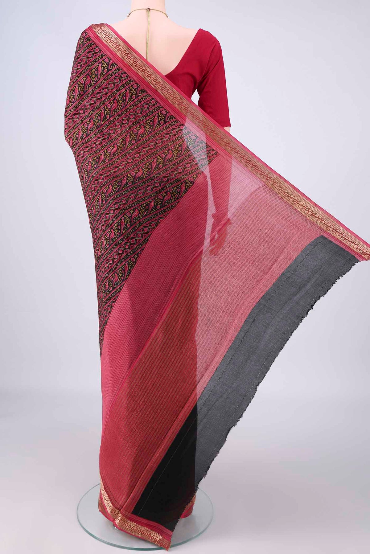 Flat view of Black Mysore Crepe Saree with Printed design on the body and Zari Border. 