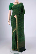 Bottle Green Mysore Crepe Saree with Printed design on the body and Zari Border.  displayed on a mannequin