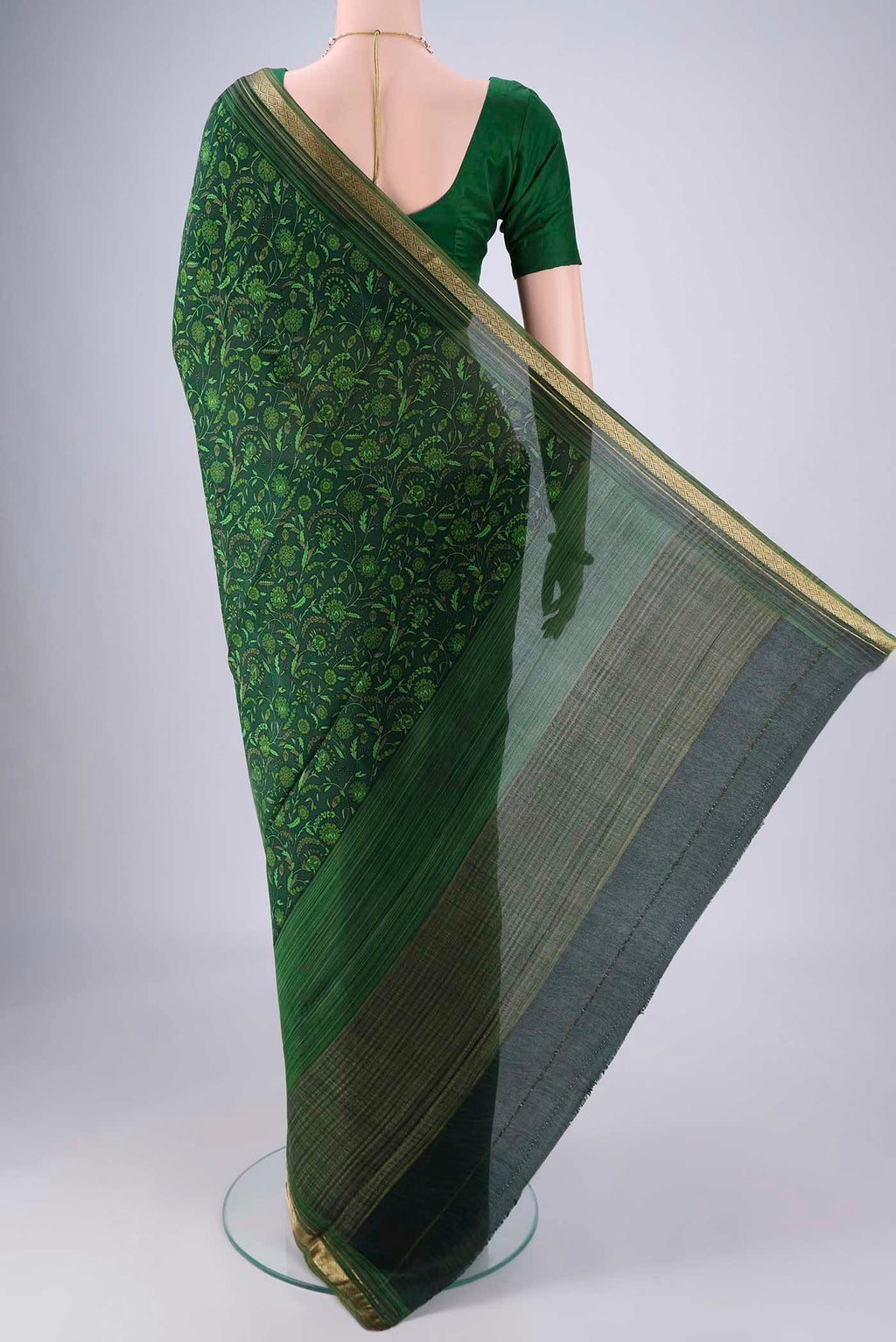 Flat view of Bottle Green Mysore Crepe Saree with Printed design on the body and Zari Border. 