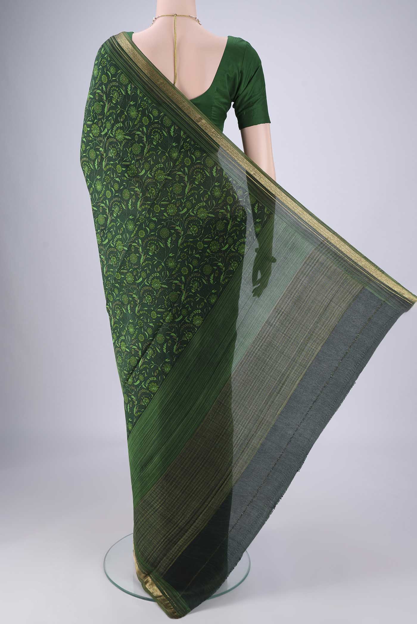 Flat view of Bottle Green Mysore Crepe Saree with Printed design on the body and Zari Border. 