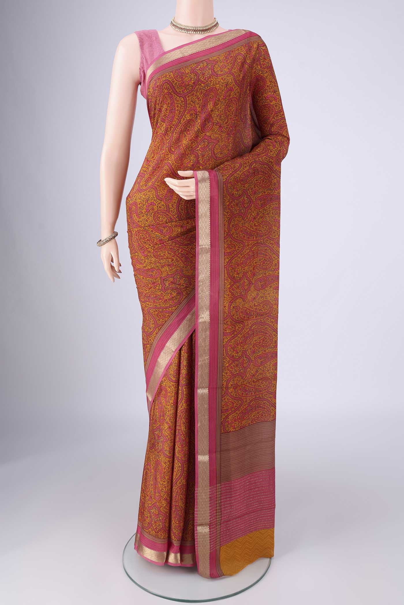 Mustard Mysore Crepe Saree with Printed design on the body and Zari Border.  displayed on a mannequin