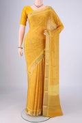 Yellow Mysore Crepe Saree with Printed design on the body and Zari Border.  displayed on a mannequin