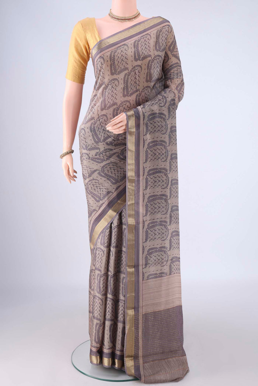 Grey Crepe Saree with Floral Print on the body and Zari Border.  displayed on a mannequin