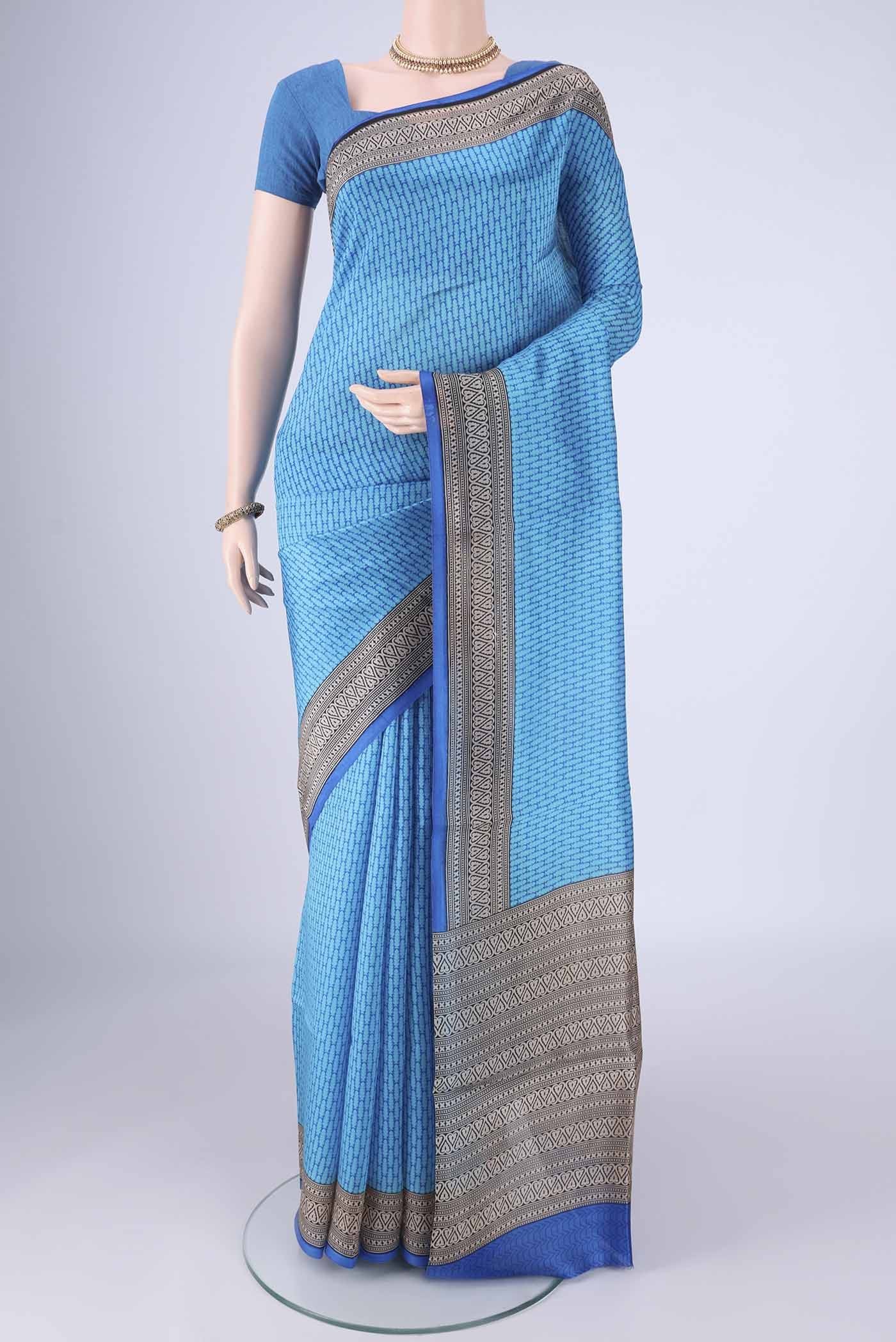 Sky Blue Printed Silk Saree with Printed design on the body and Printed Border.  displayed on a mannequin