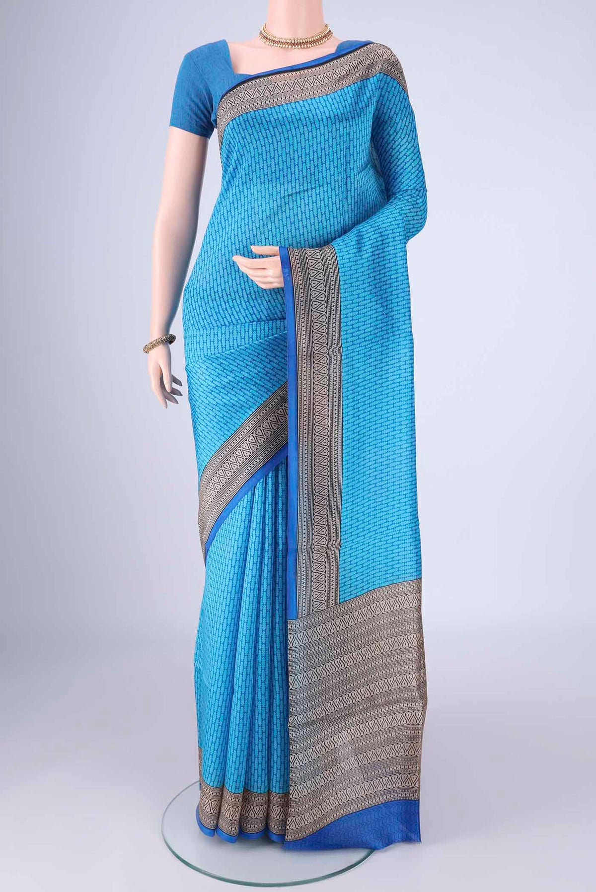 Sky Blue Printed Silk Saree with Printed design on the body and Printed Border.  displayed on a mannequin