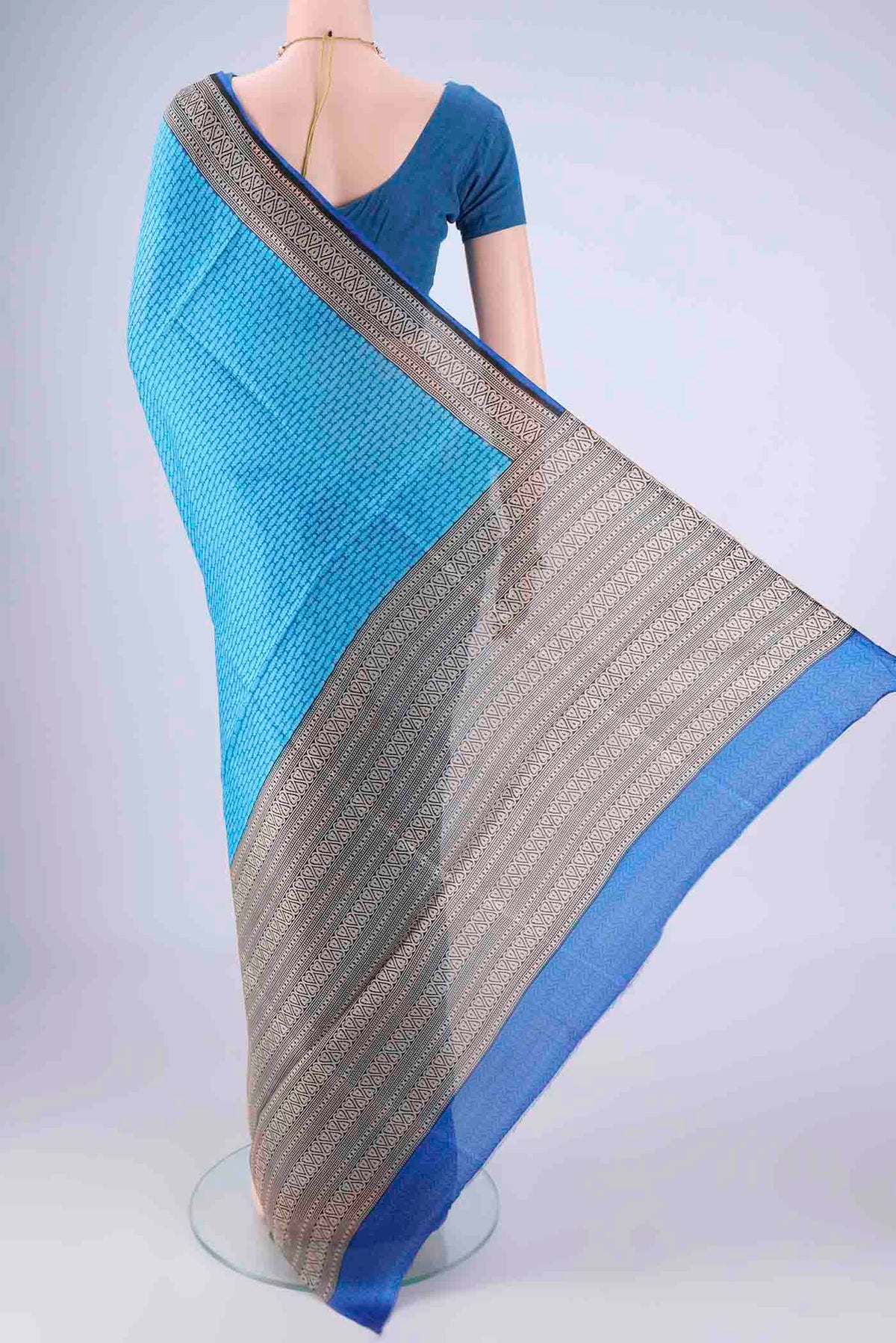 Flat view of Sky Blue Printed Silk Saree with Printed design on the body and Printed Border. 