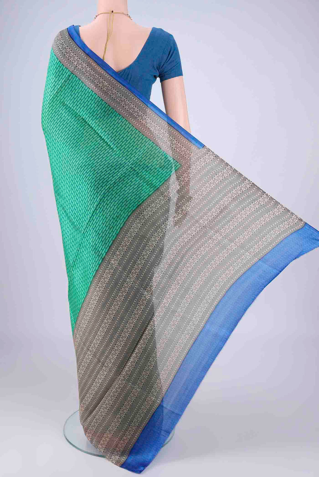 Flat view of Green Printed Silk Saree with Printed design on the body and Printed Border. 