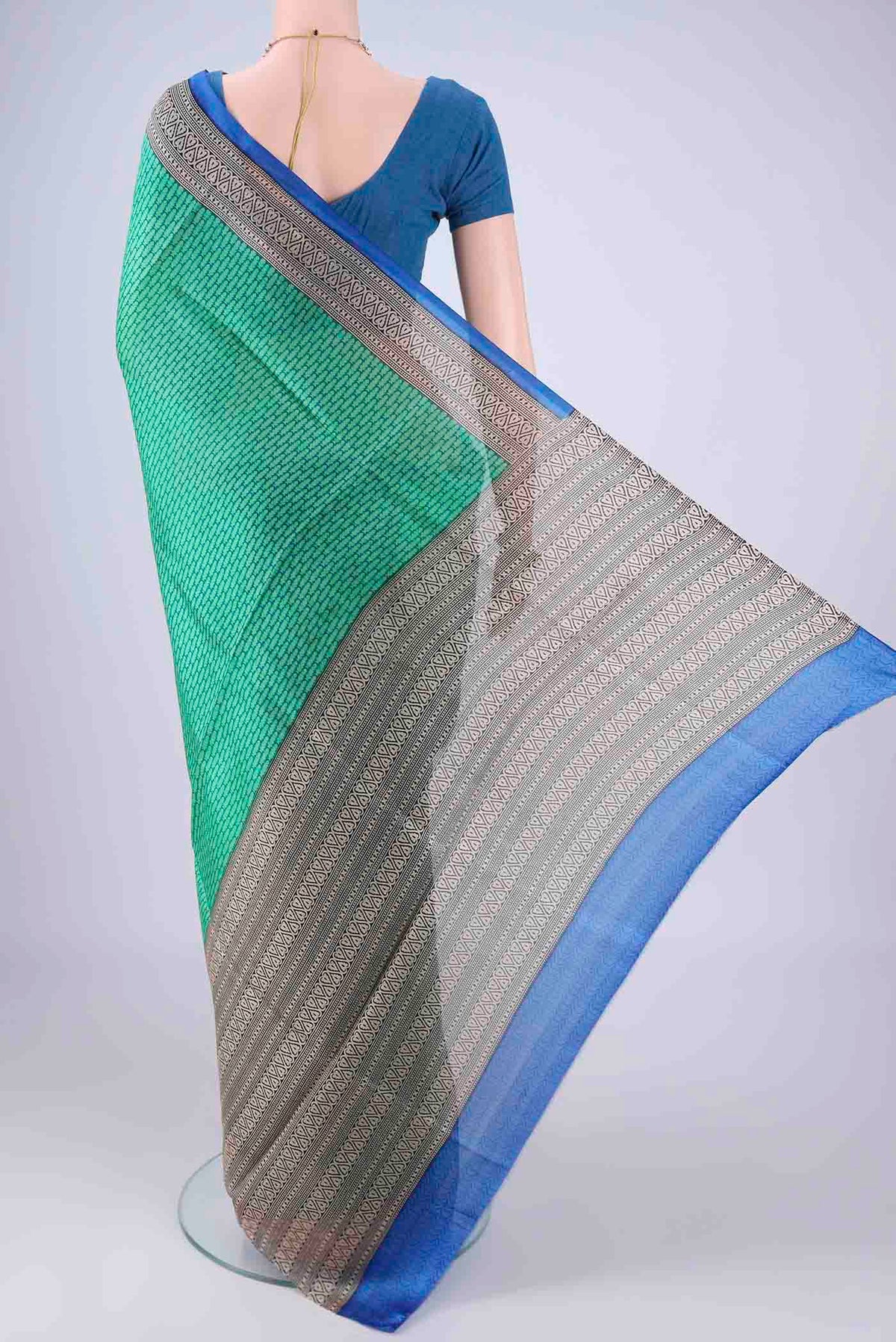 Flat view of Green Printed Silk Saree with Printed design on the body and Printed Border. 