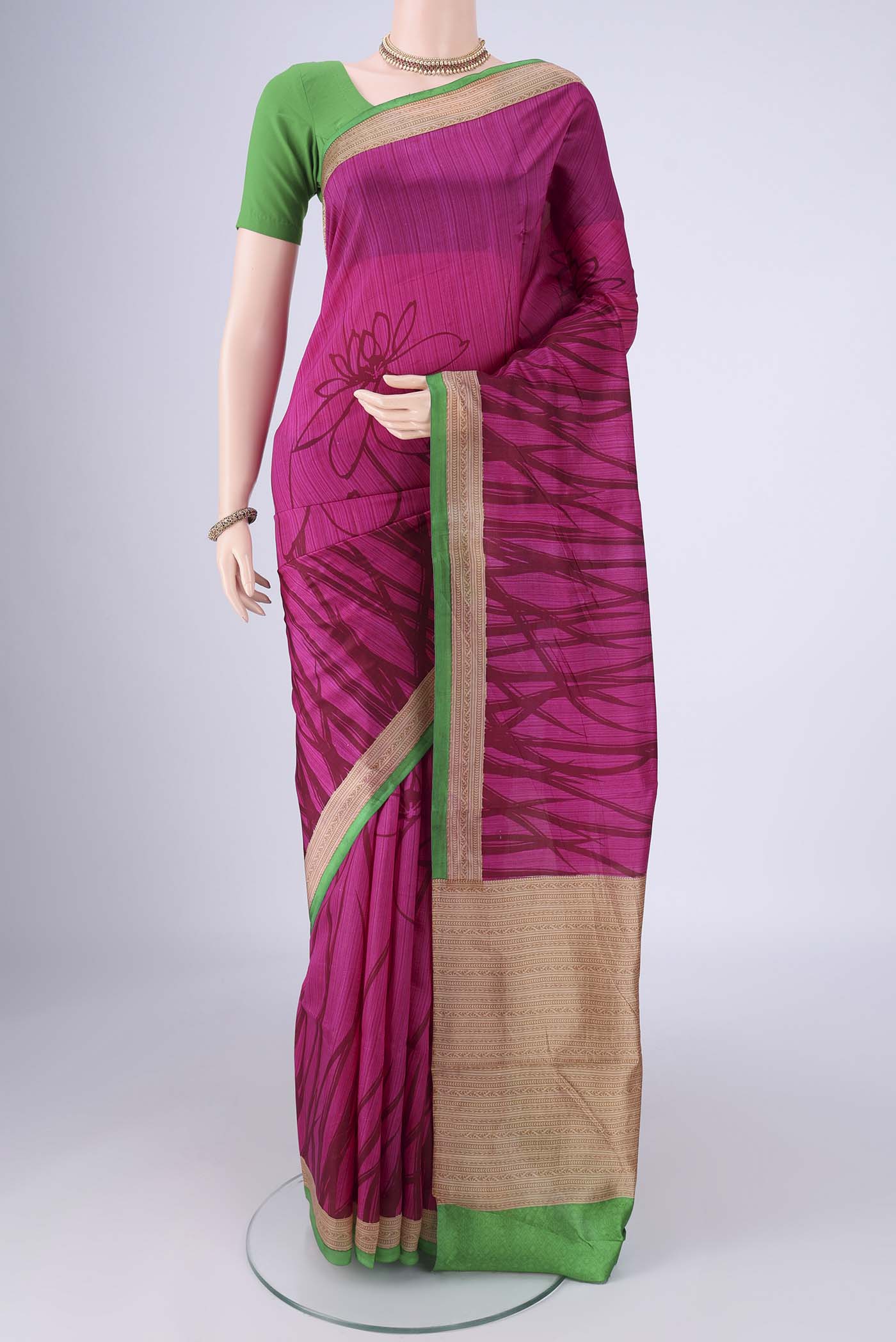 Rani Pink Printed Silk Saree with Printed design on the body and Printed Border.  displayed on a mannequin