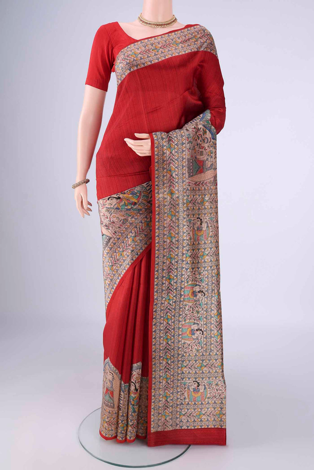 Red Printed Silk Saree with Printed design on the body and Printed Border.  displayed on a mannequin