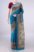 Pure Silk Blue Printed Saree with Printed design on the body and Printed Border.  displayed on a mannequin