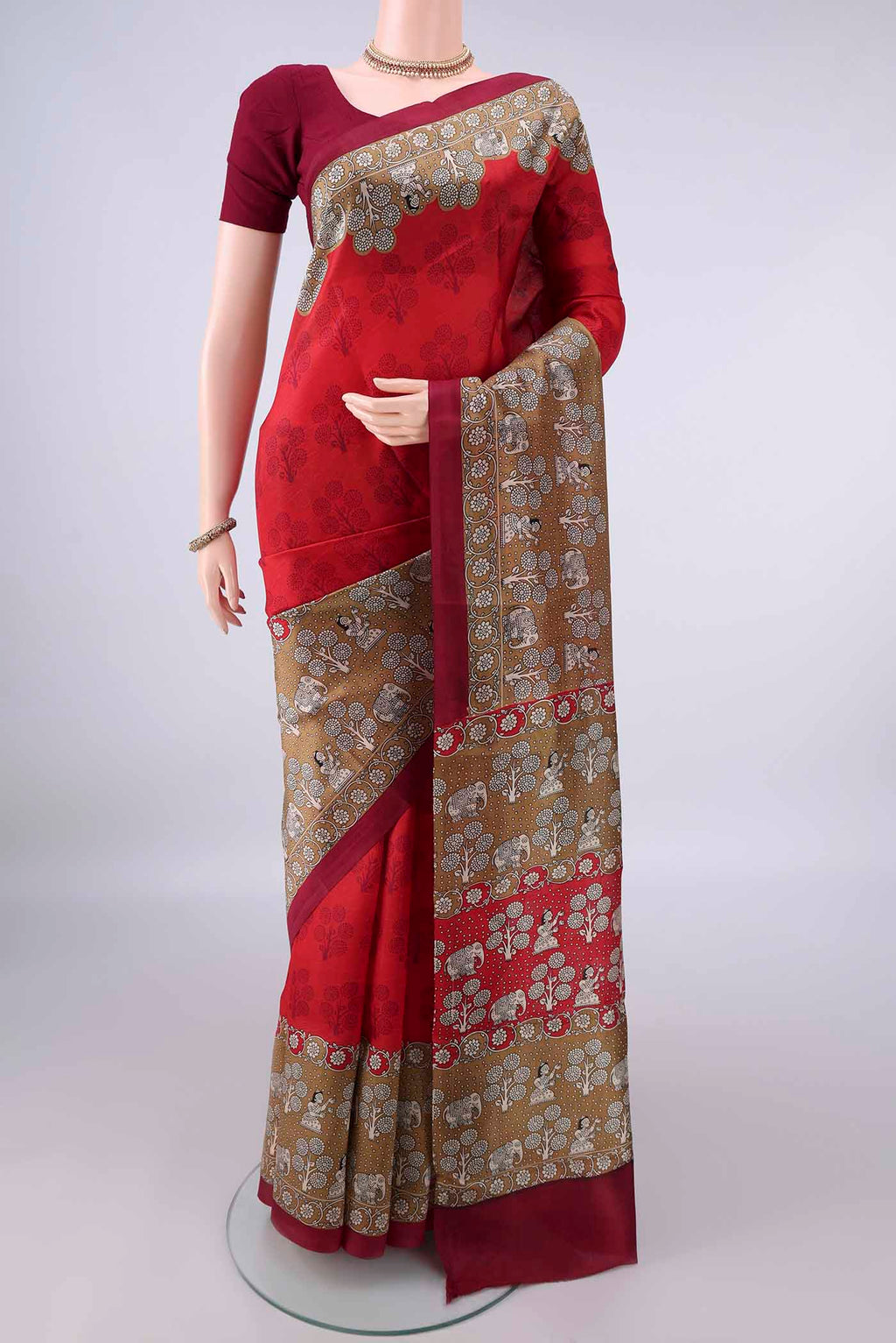Pure Silk Red Printed Saree with Printed design on the body and Printed Border.  displayed on a mannequin
