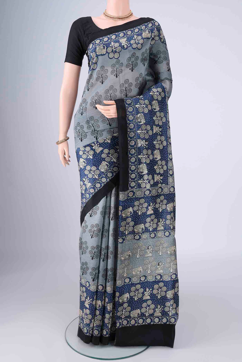 Davys Grey Printed Silk Saree with Printed design on the body and Printed Border.  displayed on a mannequin