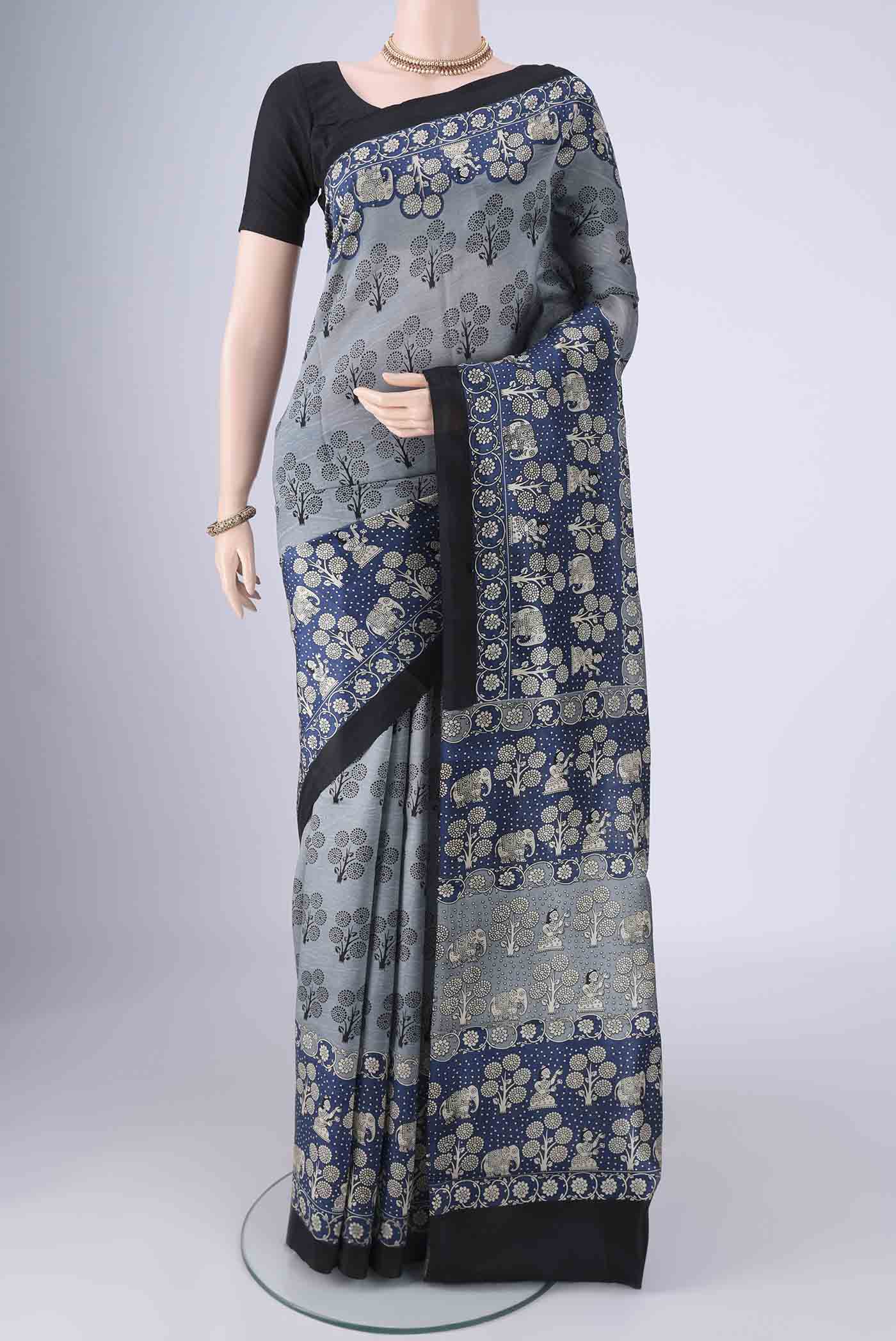 Davys Grey Printed Silk Saree with Printed design on the body and Printed Border.  displayed on a mannequin