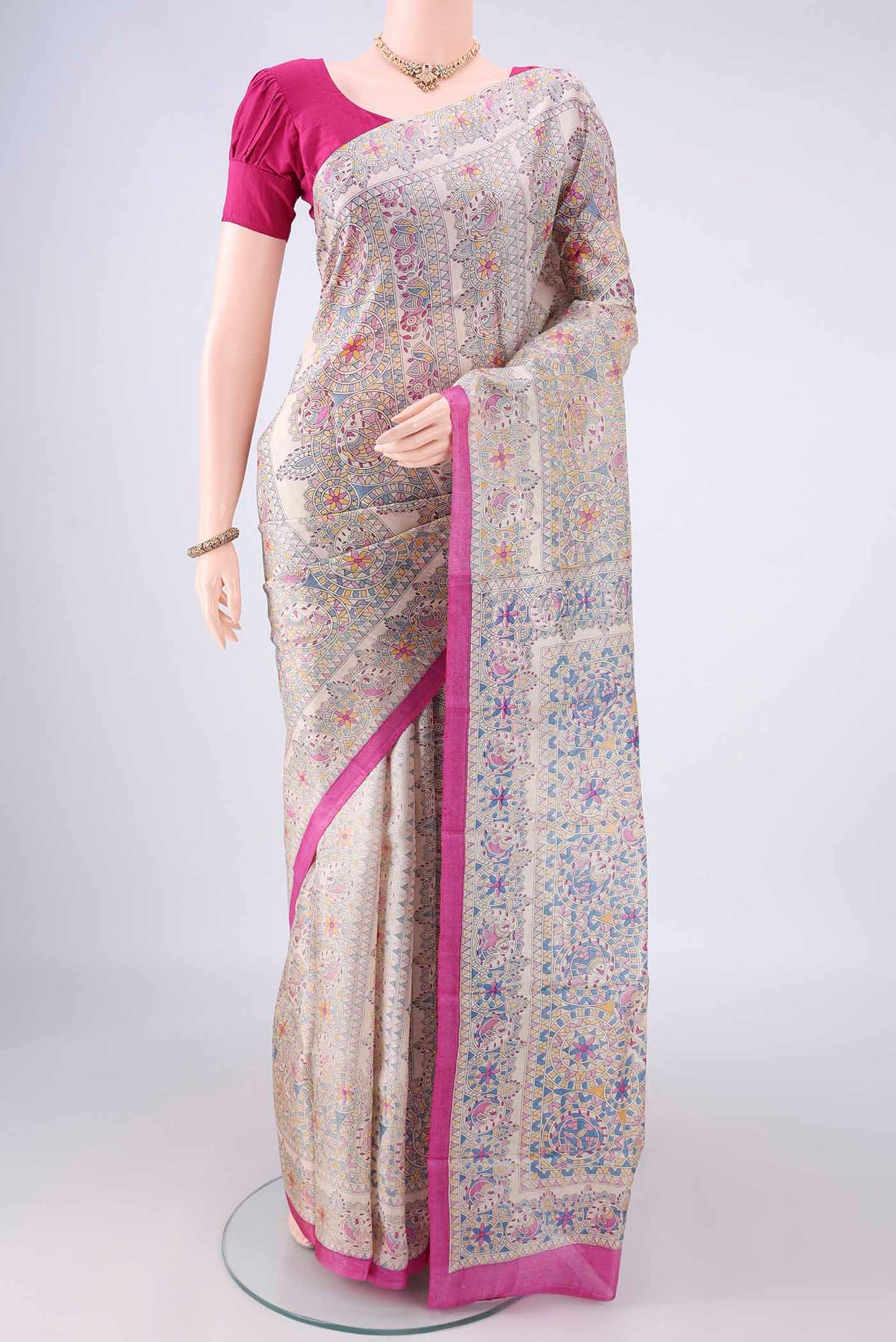 Beige Tussar Saree with Printed design on the body and Printed Border.  displayed on a mannequin