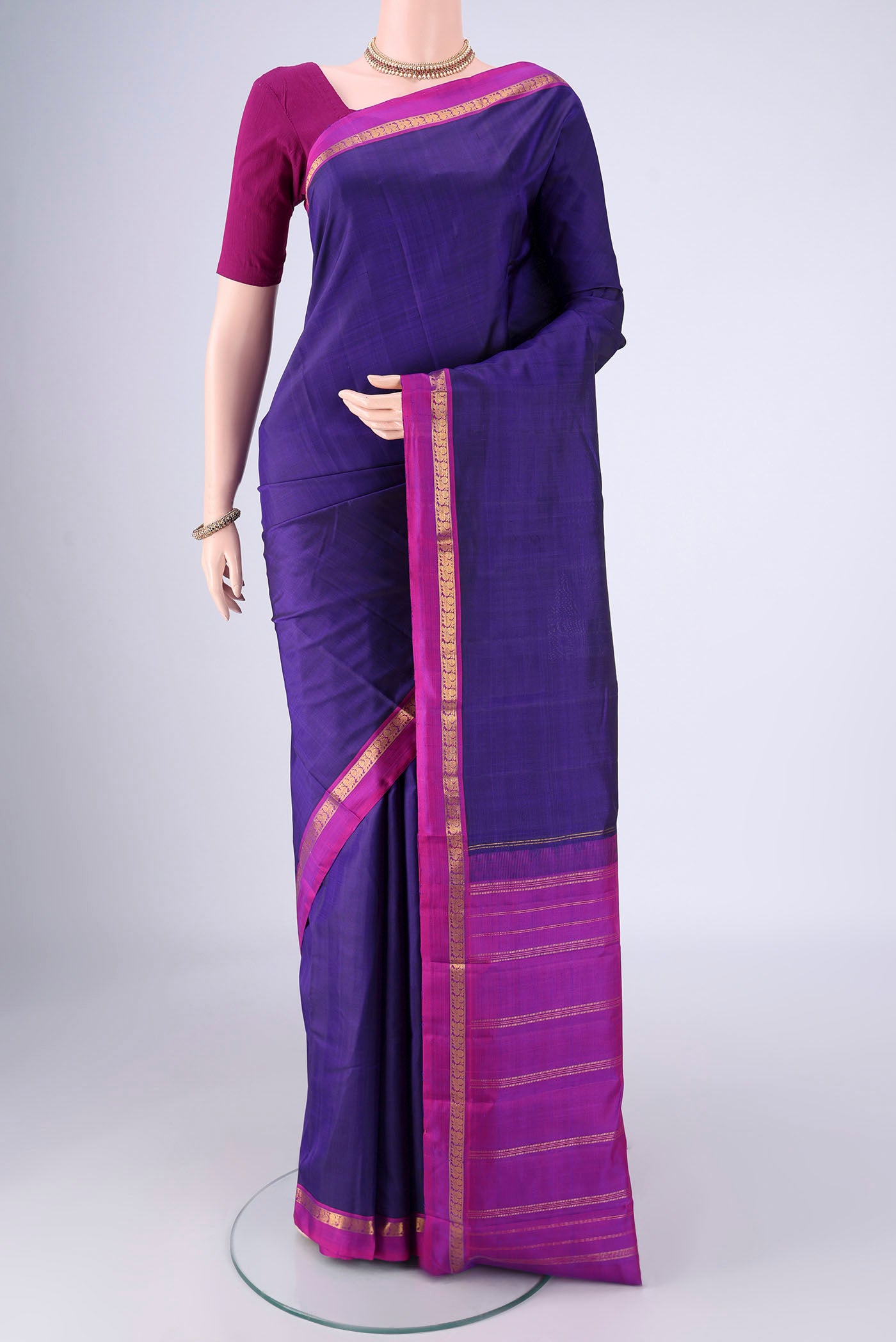 Blue Kanjivaram Silk Saree with Plain Body and Zari Border.  displayed on a mannequin