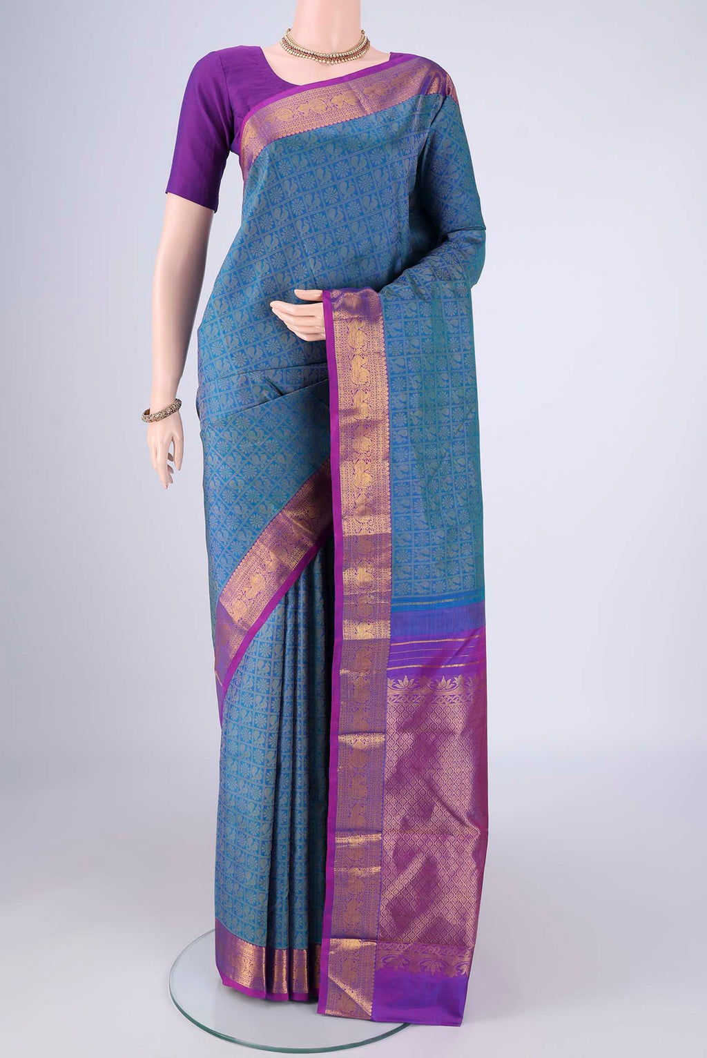 Blue Kanjivaram Silk Saree with Jacquard design on the body and Zari Border.  displayed on a mannequin