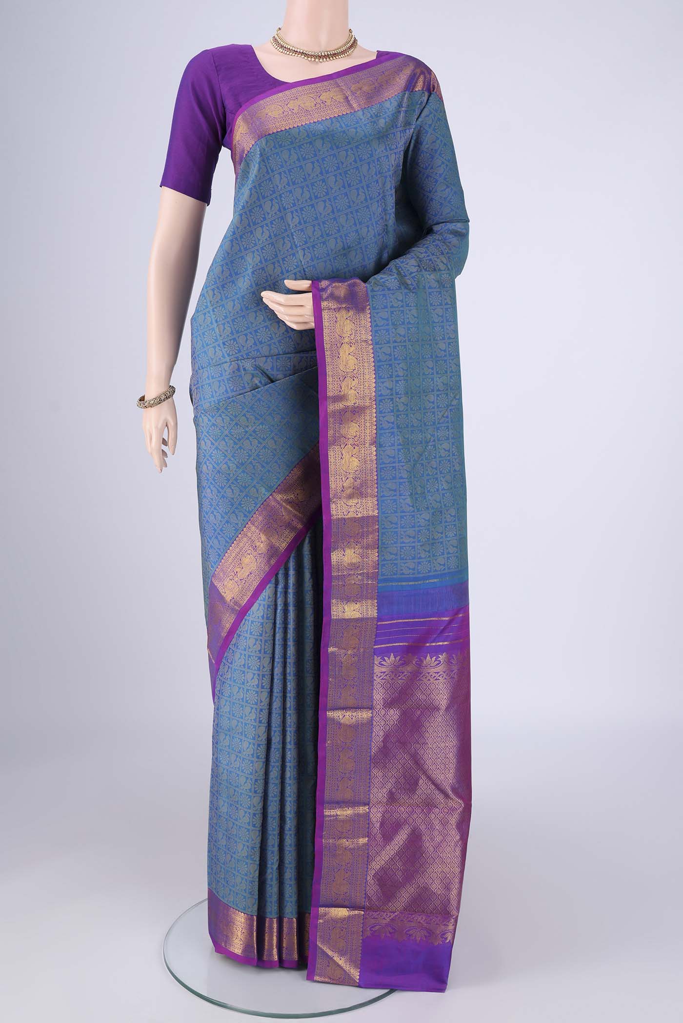 Blue Kanjivaram Silk Saree with Jacquard design on the body and Zari Border.  displayed on a mannequin