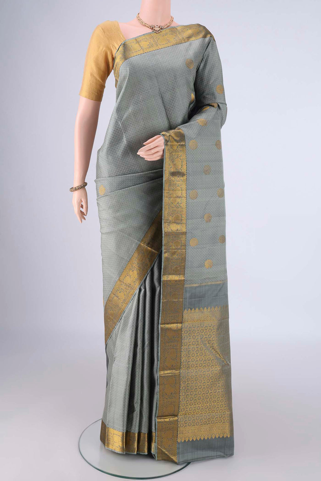Davys Grey Kanjivaram Silk Saree with Jacquard With Zari Butta on the body and Zari Border.  displayed on a mannequin