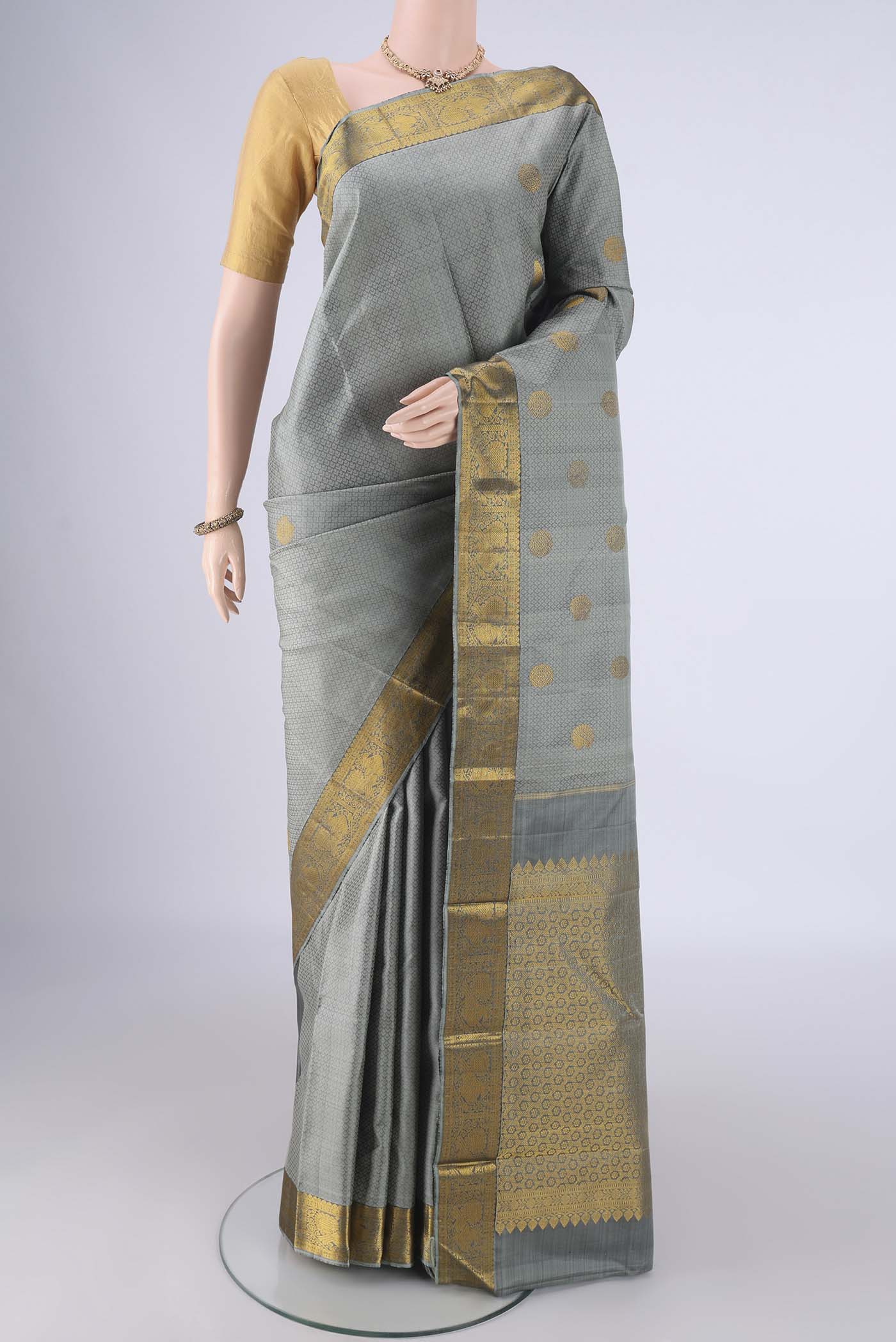 Davys Grey Kanjivaram Silk Saree with Jacquard With Zari Butta on the body and Zari Border.  displayed on a mannequin