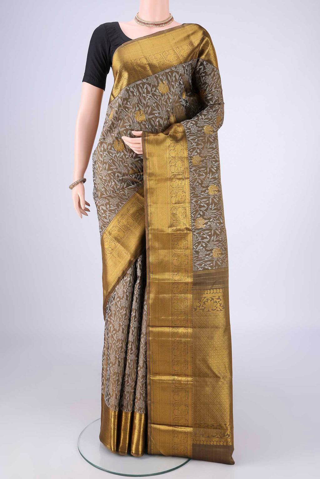 Mehandi Green Kanjivaram Silk Saree with Jacquard With Zari Butta on the body and Zari Border.  displayed on a mannequin