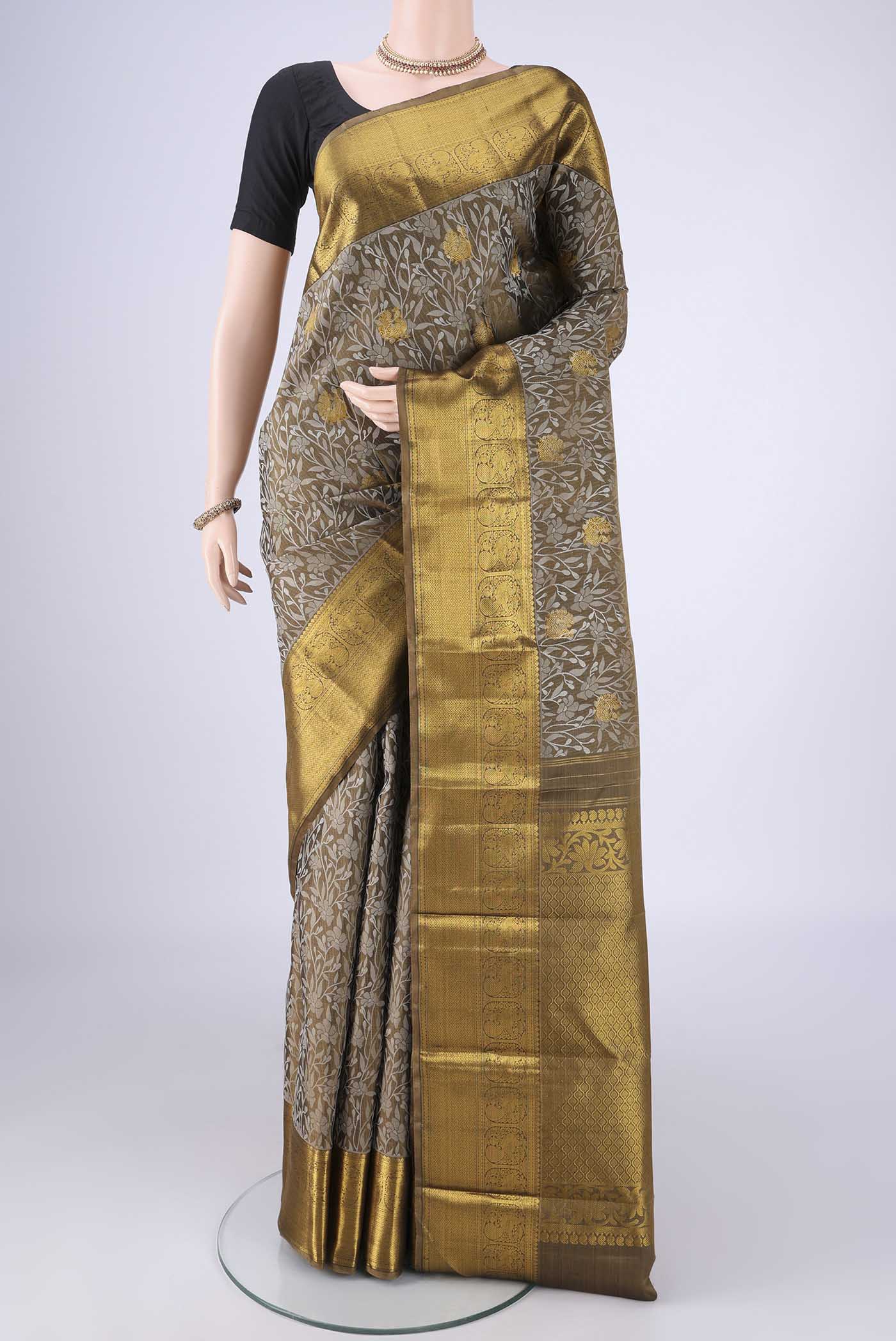 Mehandi Green Kanjivaram Silk Saree with Jacquard With Zari Butta on the body and Zari Border.  displayed on a mannequin