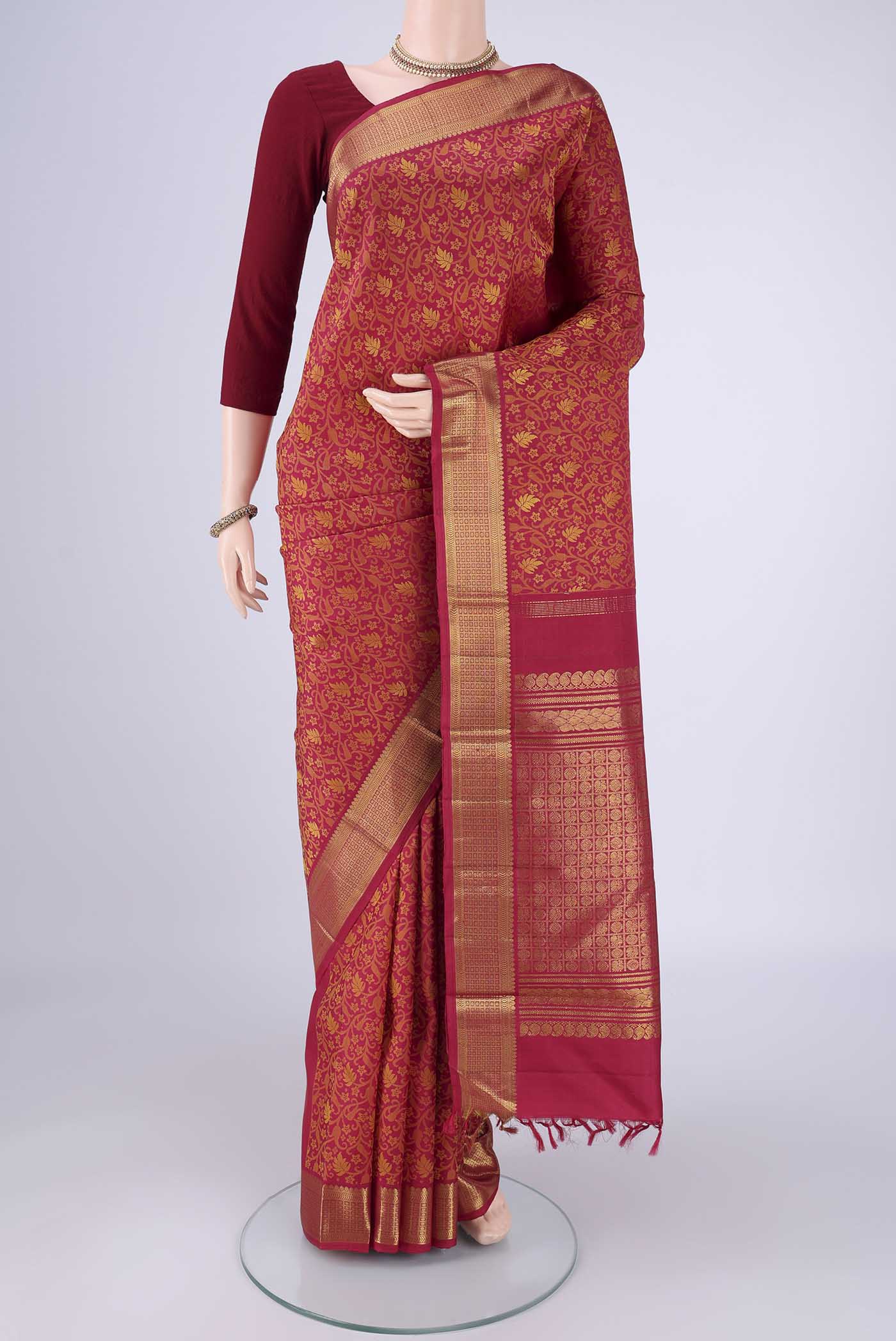 Maroon Kanjivaram Silk Saree with Jacquard design on the body and Zari Border.  displayed on a mannequin