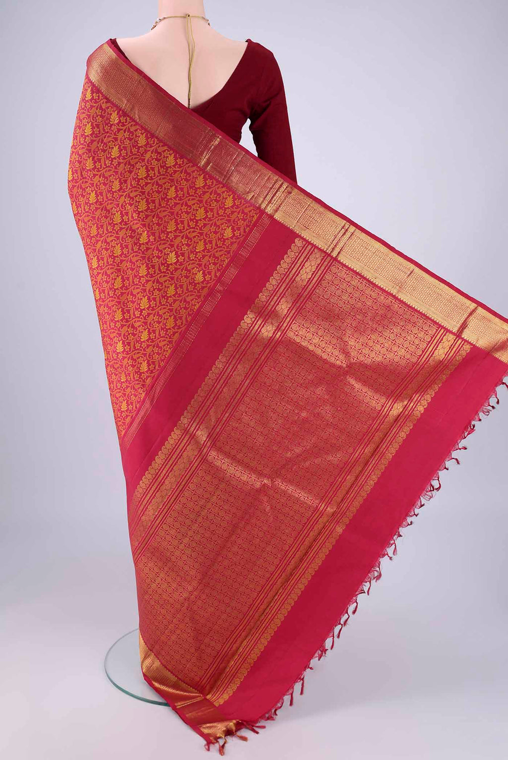 Flat view of Maroon Kanjivaram Silk Saree with Jacquard design on the body and Zari Border. 
