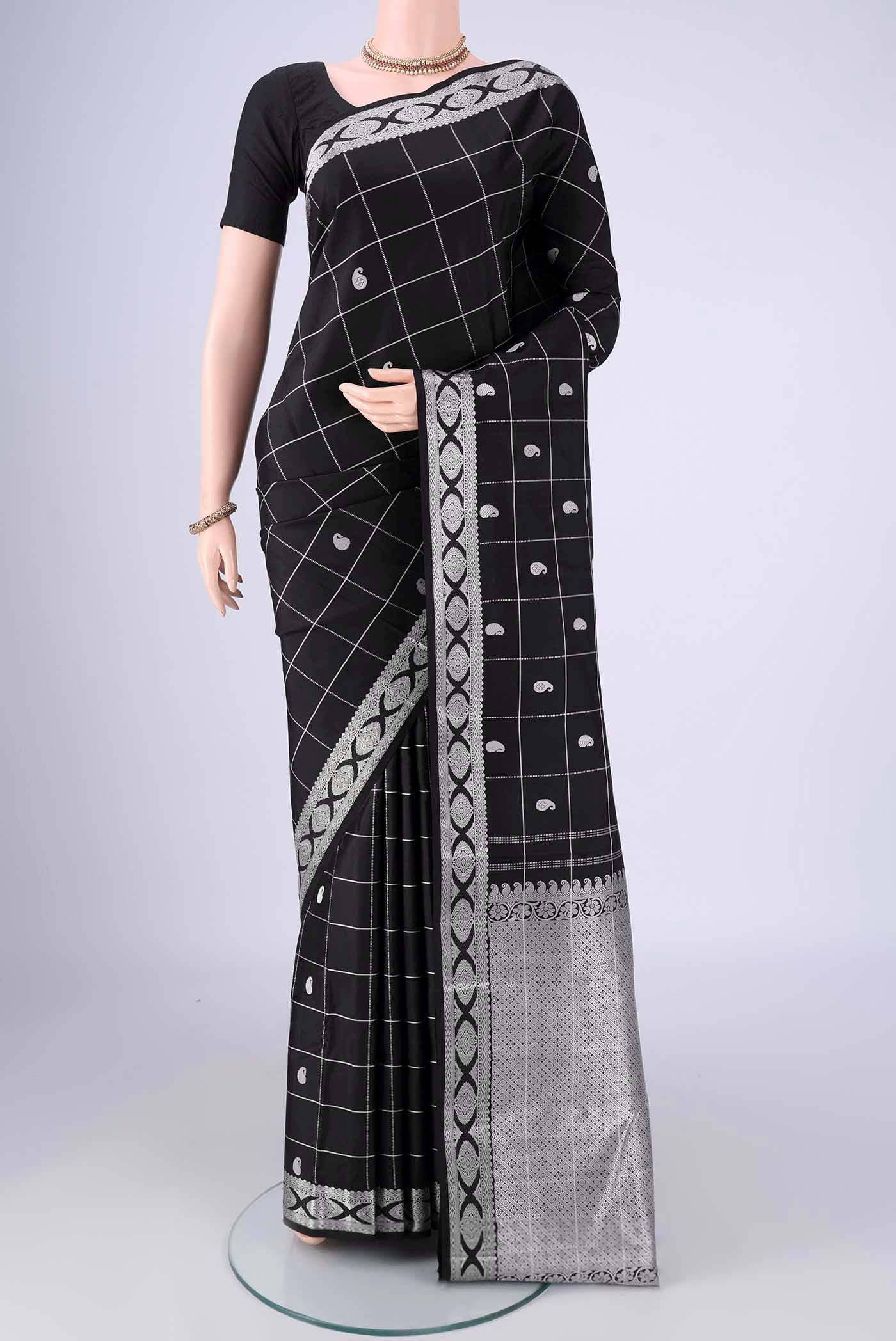 Black Kanjivaram Silk Saree with Thread Butta on the body and Thread Border.  displayed on a mannequin
