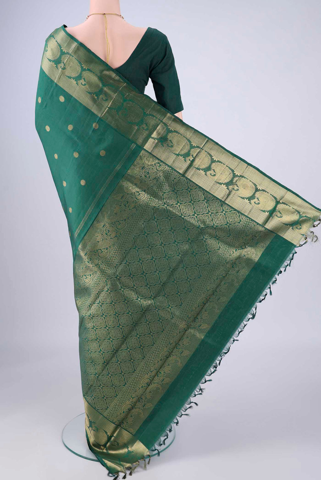 Flat view of Bottle Green Kanjivaram Silk Saree with Zari Butta on the body and Zari Border. 