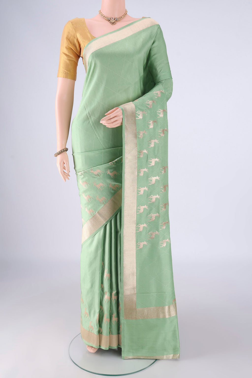 Light Green Banarasi Silk Saree with Plain Body and Zari Border.  displayed on a mannequin