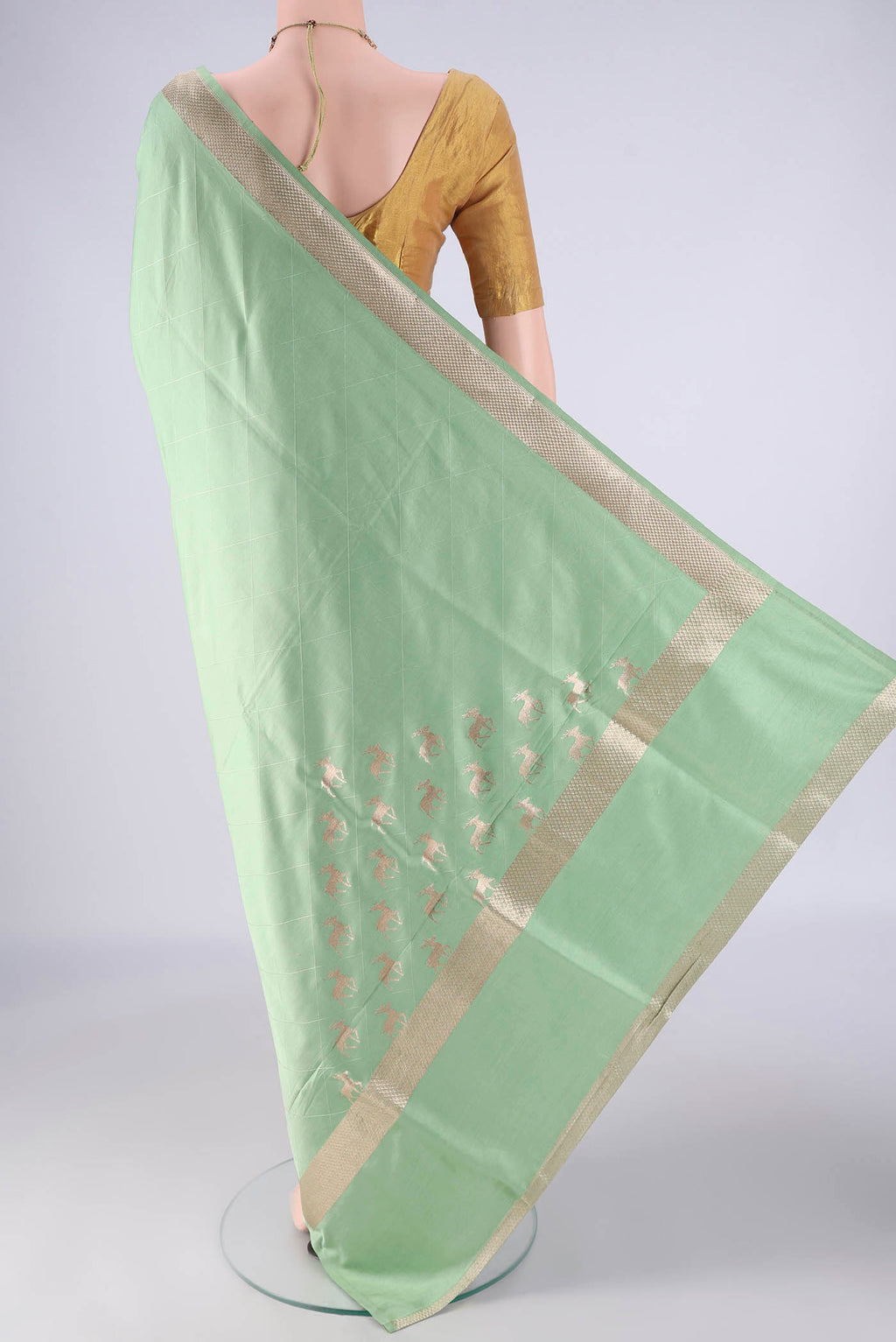 Flat view of Light Green Banarasi Silk Saree with Plain Body and Zari Border. 