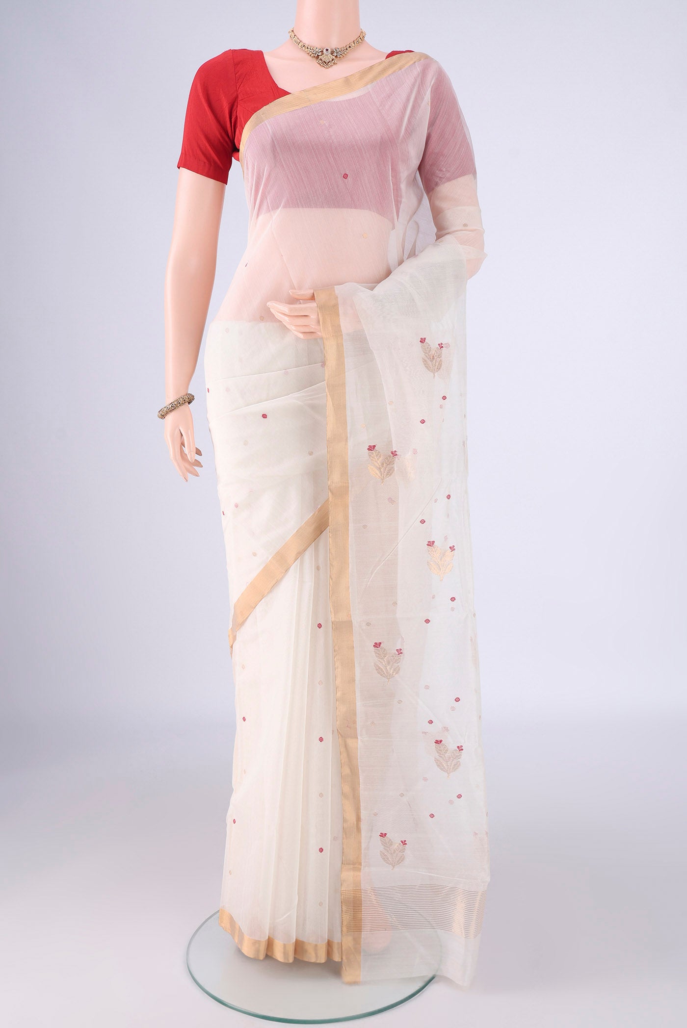Off White Chanderi Silk Cotton Saree with Zari And Thread Butta on the body and Zari Border.  displayed on a mannequin
