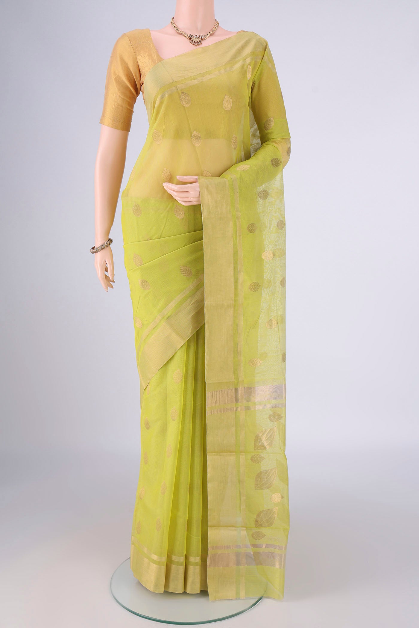 Lemon Yellow Chanderi Silk Cotton Saree with Zari Butta on the body and Zari Border.  displayed on a mannequin
