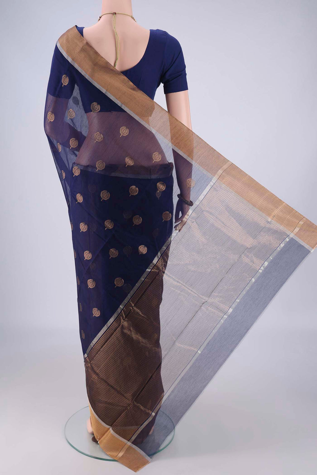 Flat view of Navy Blue Chanderi Silk Cotton Saree with Zari Butta on the body and Zari Border. 