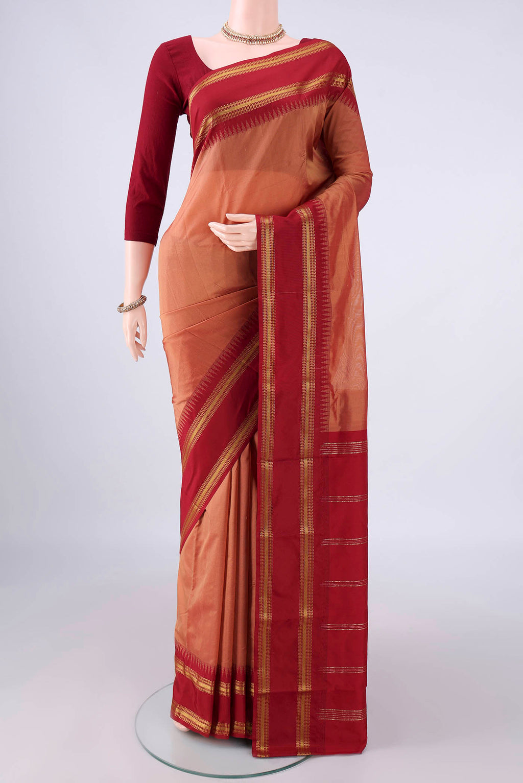 Peach Blended Bangalore Silk Saree with Plain Body and Zari Border.  displayed on a mannequin