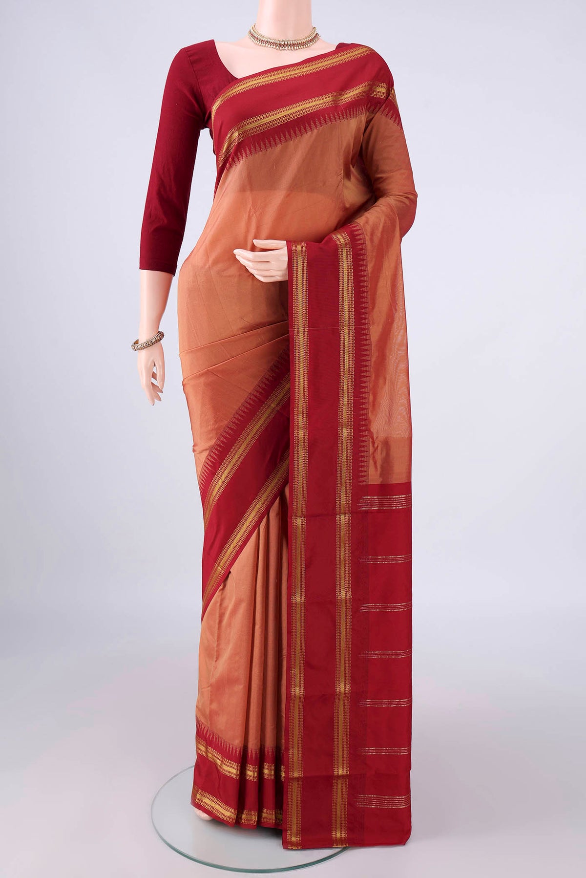 Peach Blended Bangalore Silk Saree with Plain Body and Zari Border.  displayed on a mannequin