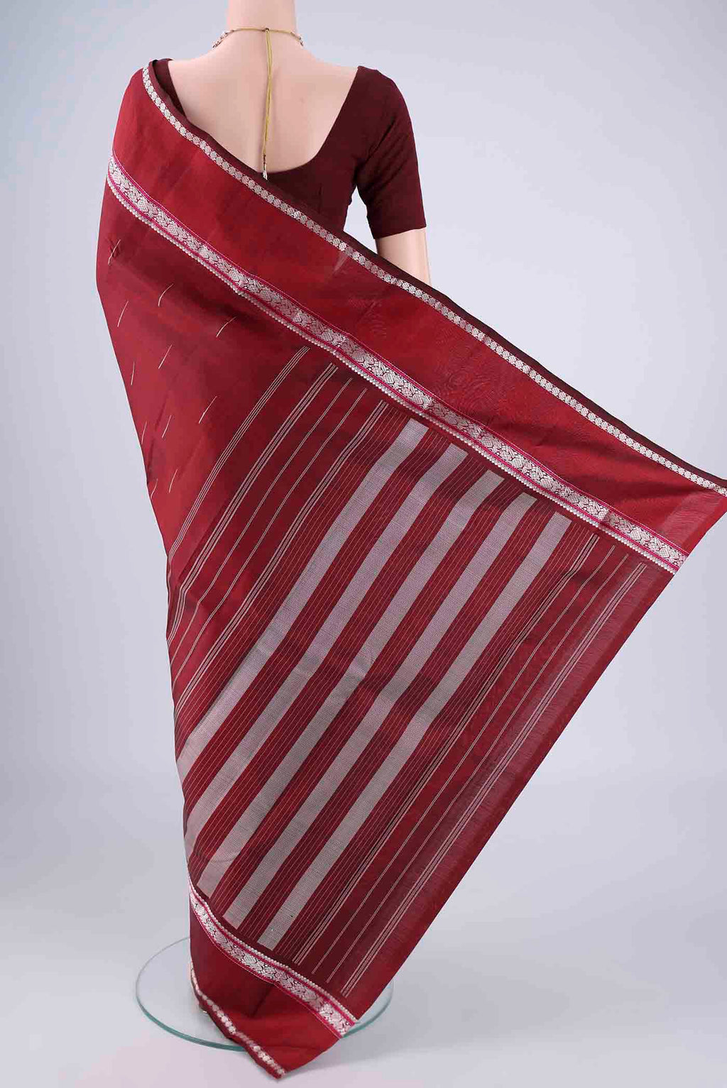 Flat view of Maroon Kanchipuram Silk Saree with Thread Butta on the body and Thread Border. 